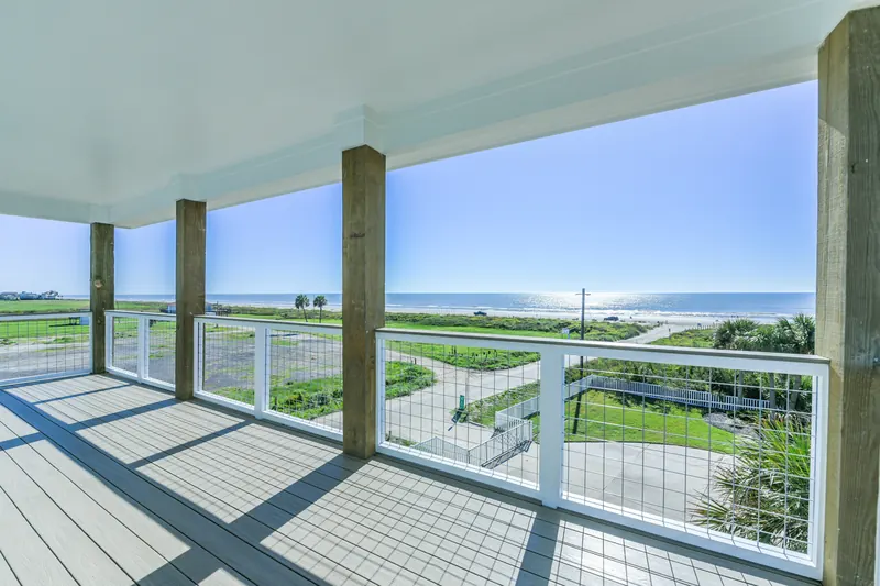 Upper deck at 11 Mile with cable railing framing an unobstructed view across the prairie toward the Gulf