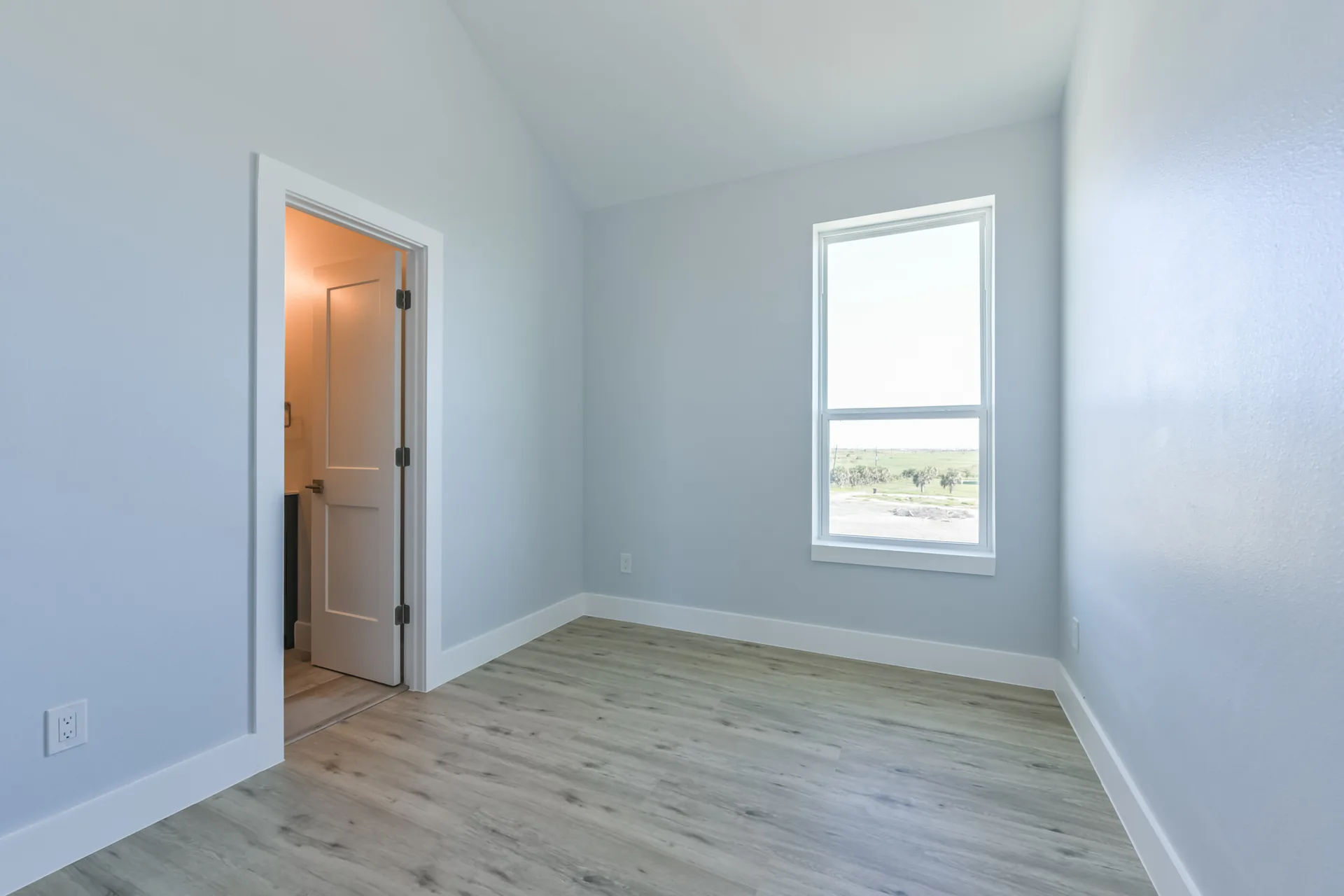 Bedroom at 11 Mile with a private door to the hall bath and pale coastal wall color
