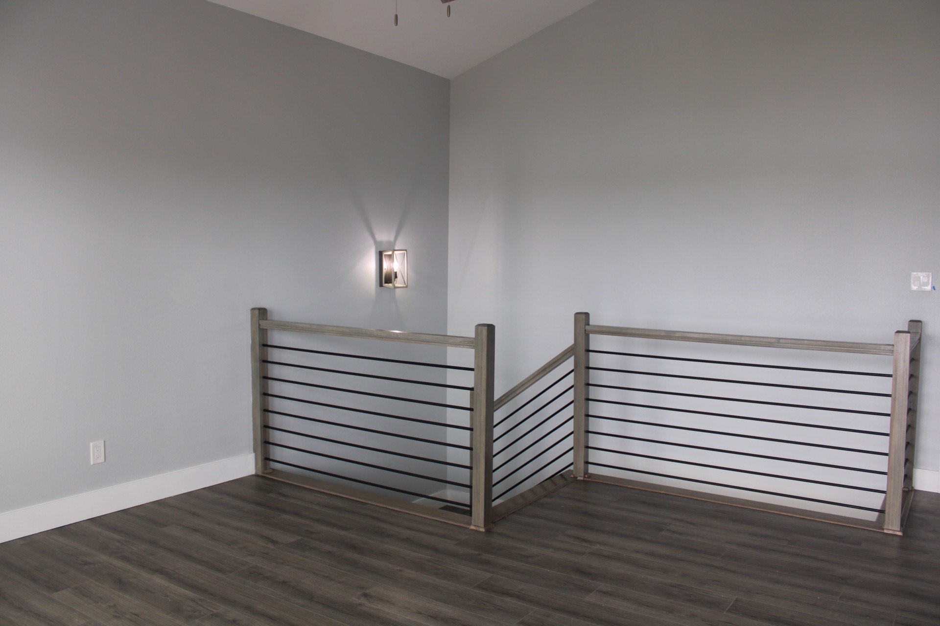 Third bathroom with compact design, marble-look tile shower enclosure, contemporary fixtures, and dark plank flooring for a cohesive modern coastal feel