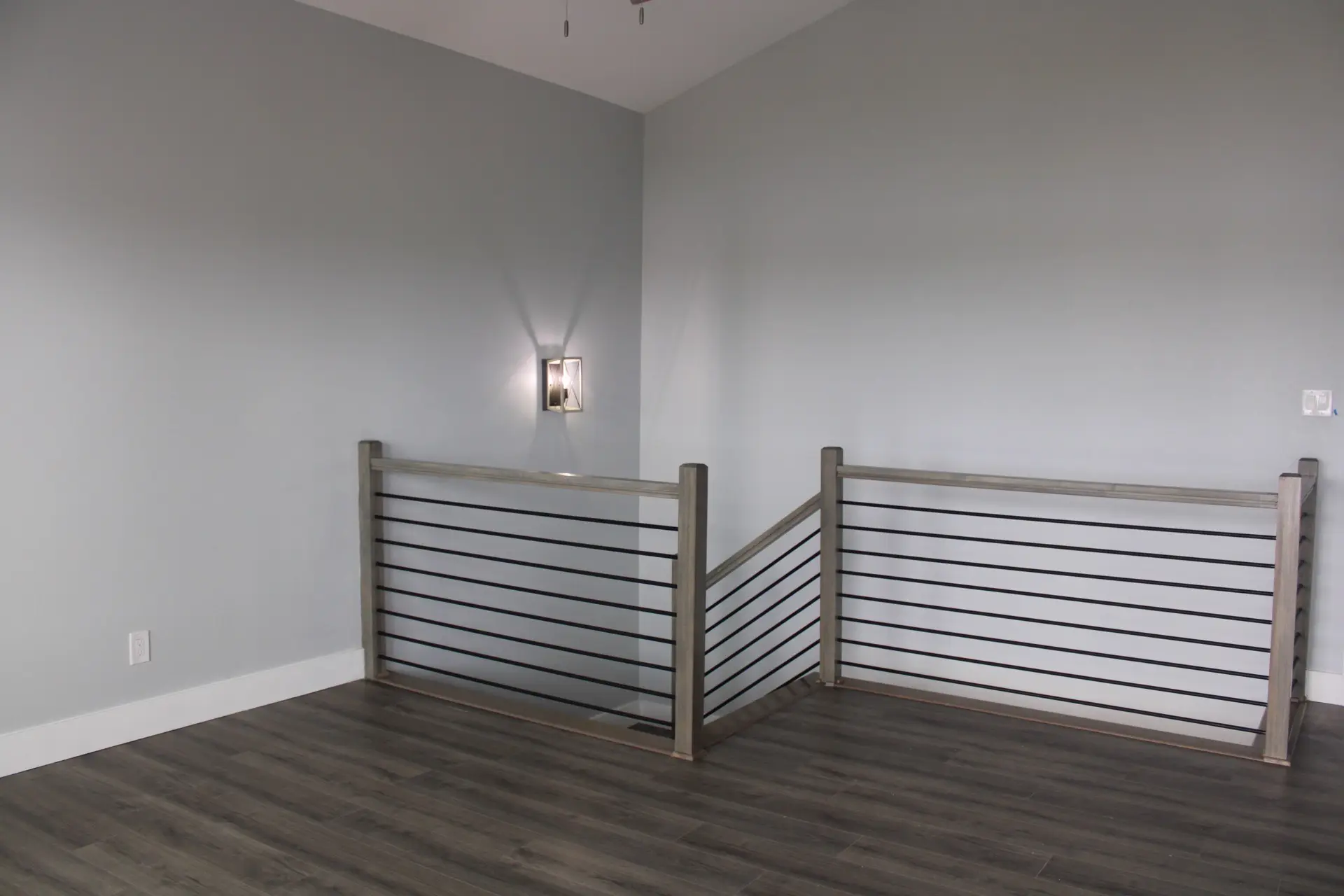 Third bathroom with compact design, marble-look tile shower enclosure, contemporary fixtures, and dark plank flooring for a cohesive modern coastal feel