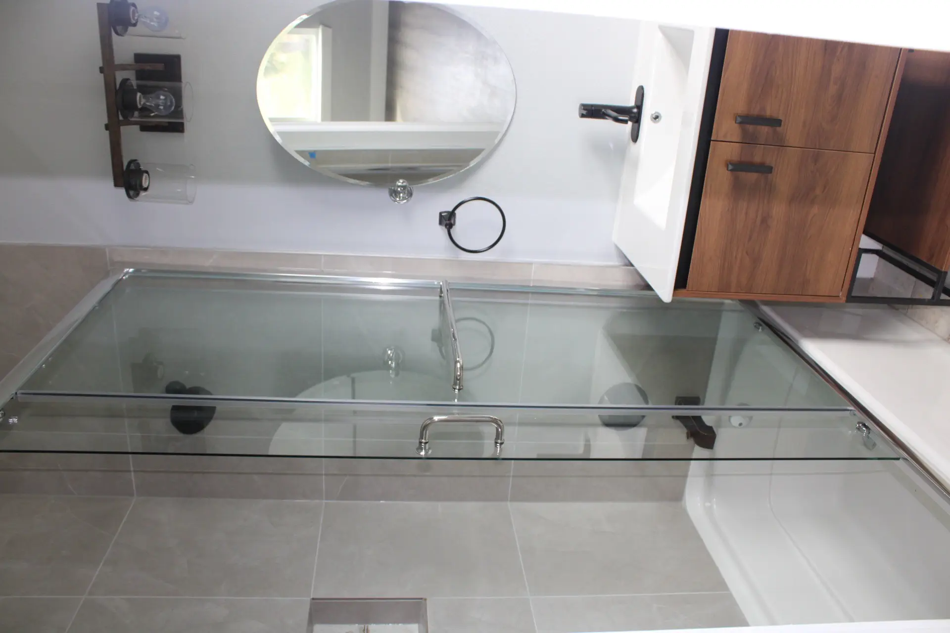 Entry-level hallway with contemporary wall sconces casting warm light across white walls and dark wood-look flooring