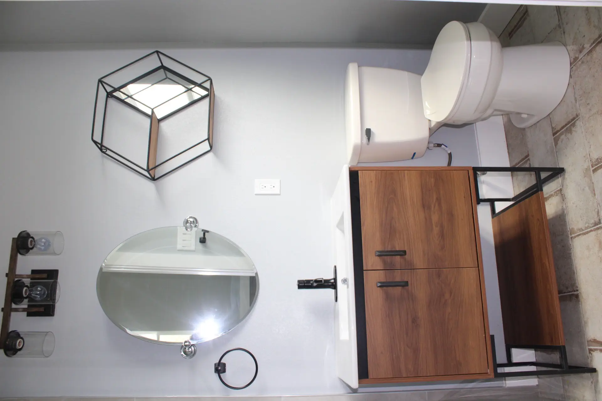 Transitional space between levels with the horizontal metal railing, natural light from a stairwell window, and clean modern trim details