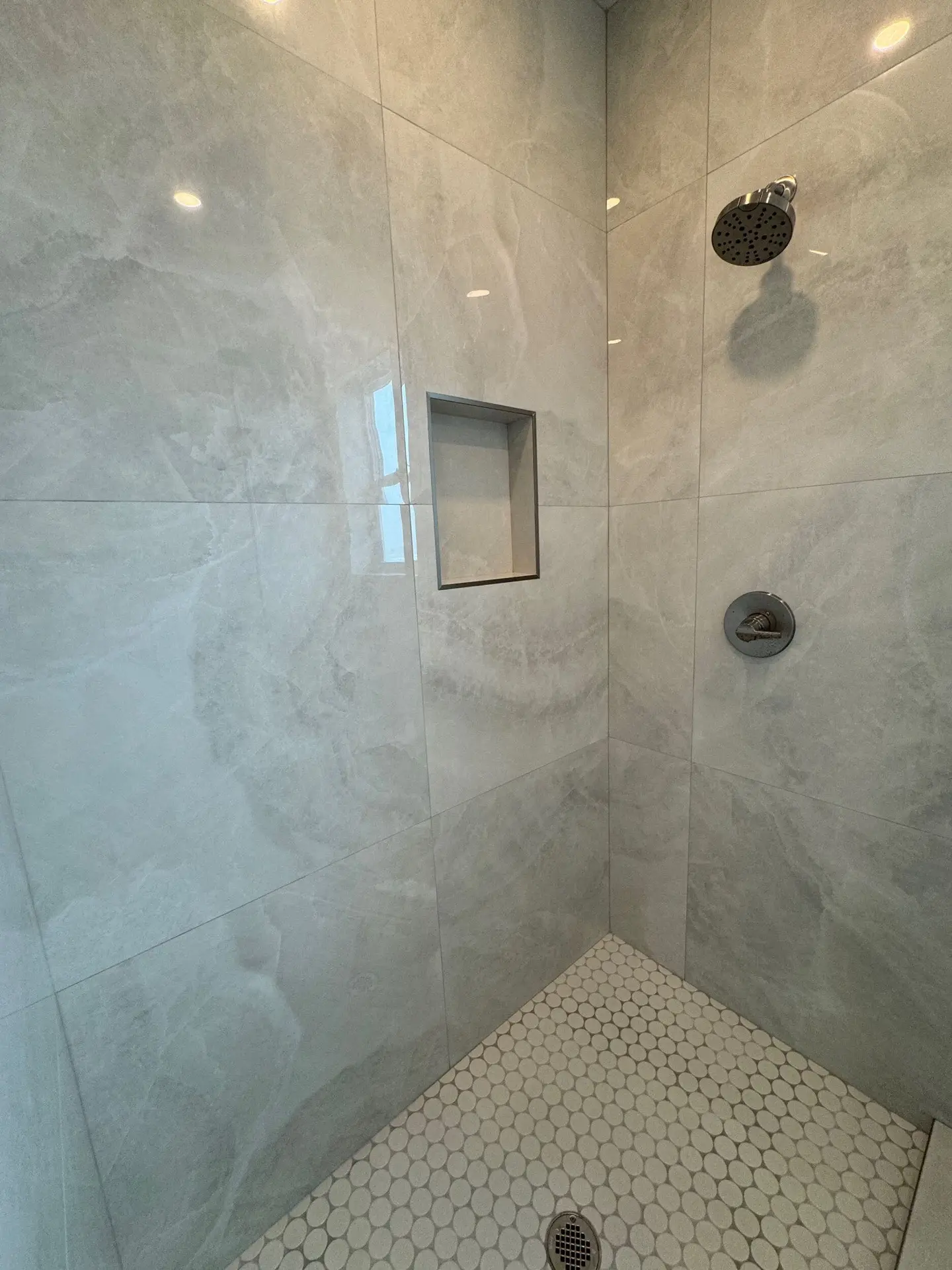 Bright guest bedroom featuring coastal neutral palette, light oak flooring, and large window framing Gulf Drive scenery
