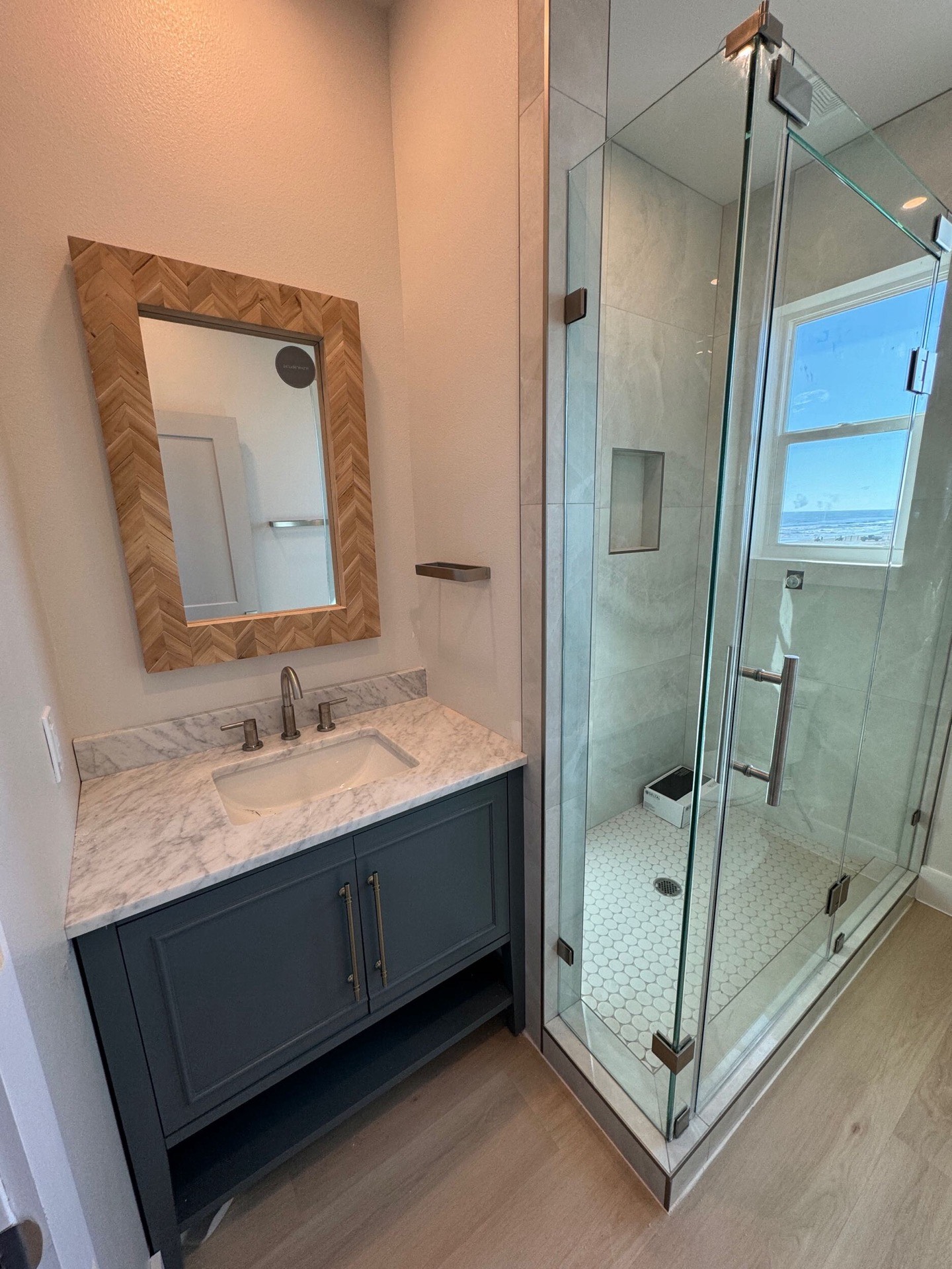 Side exterior view highlighting the elevated coastal structure with covered porches on both levels and durable metal roofing