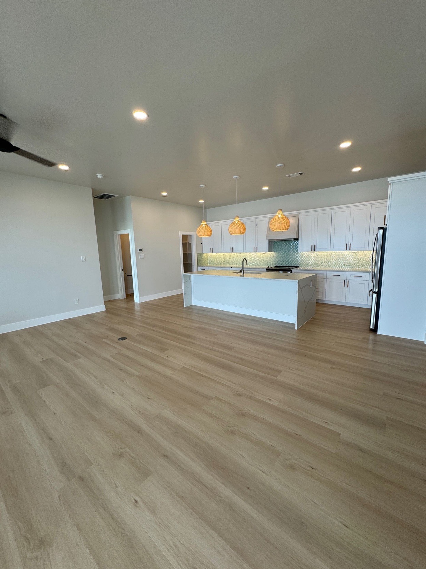 Secondary bath shower with white subway tile walls, glass enclosure, and decorative hexagonal tile floor continuing from the vanity area