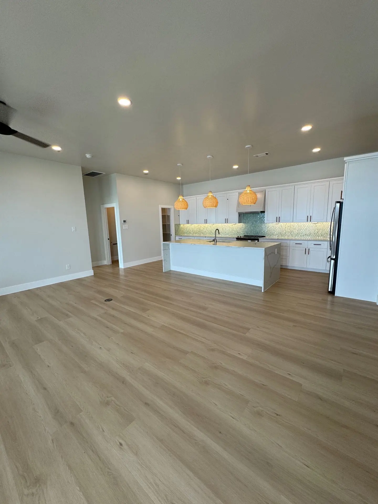 Secondary bath shower with white subway tile walls, glass enclosure, and decorative hexagonal tile floor continuing from the vanity area
