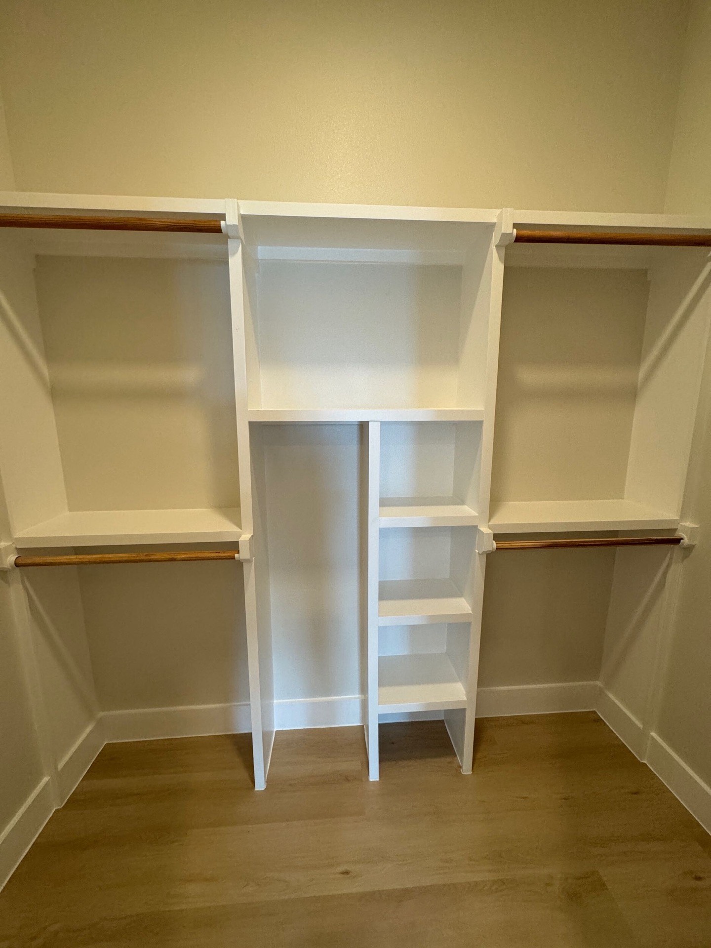 Kitchen viewed from the dining area with floor-to-ceiling cabinetry, gold hardware accents, and natural light from coastal windows