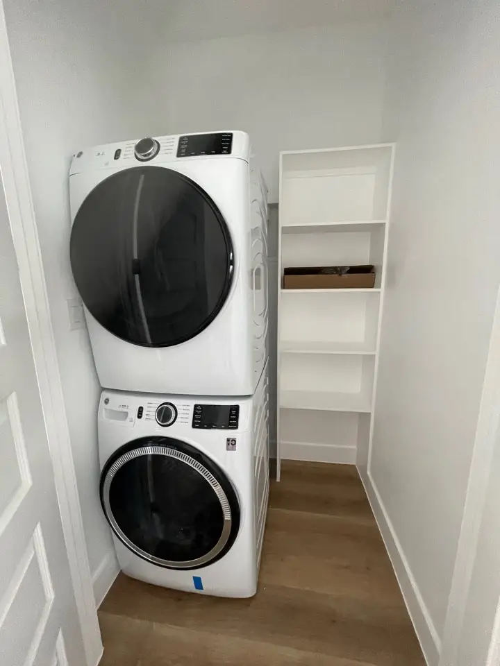 Marble fireplace detail showing veined white marble from hearth to ceiling with modern linear gas insert in the two-story great room