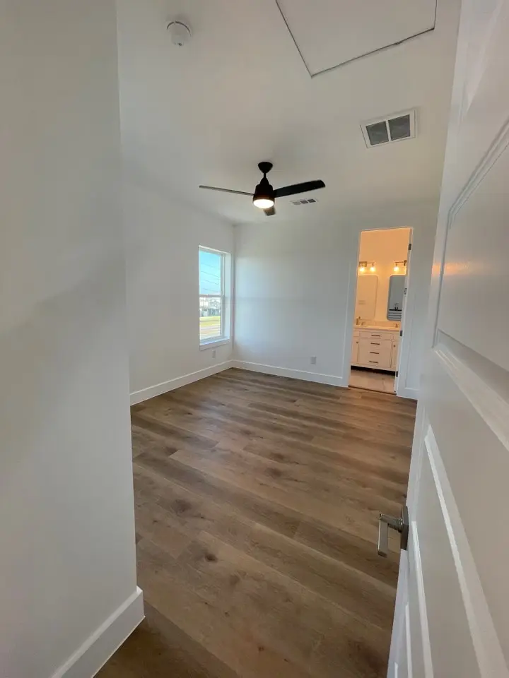 View from the upper loft showing the full scale of the two-story great room, marble fireplace, and open-concept living layout