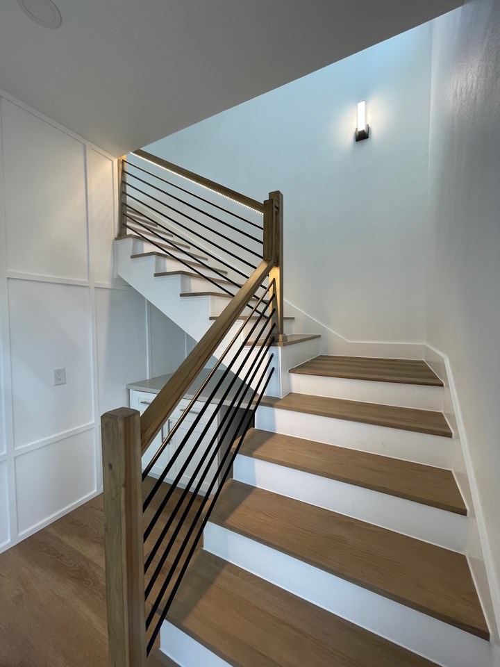 Freestanding jetted tub in the master bath with marble tile surround and brass faucet hardware in the Gulf Drive coastal home