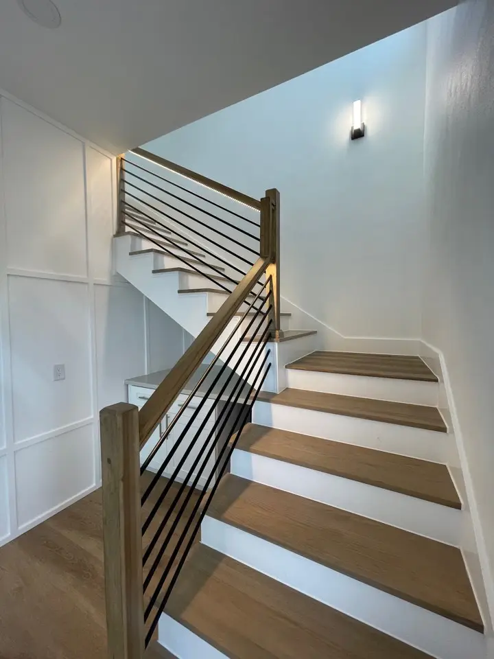 Freestanding jetted tub in the master bath with marble tile surround and brass faucet hardware in the Gulf Drive coastal home