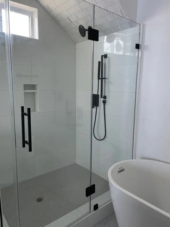 Master bedroom with light oak hardwood floors, large windows with Gulf of Mexico views, and coastal-neutral color palette