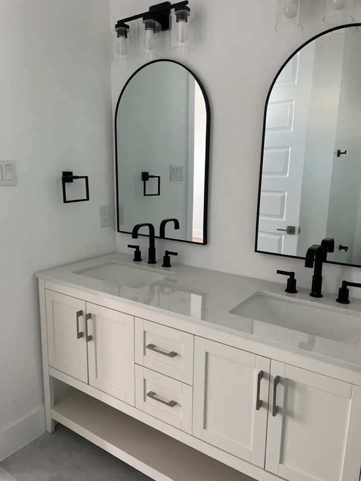 Master suite walk-in closet with custom built-in shelving, hanging rods, and drawer storage in the 131 Gulf Drive home