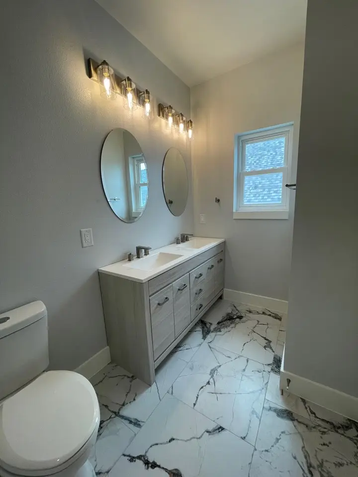 Open loft mezzanine overlooking the double-height main living area below with light wood-look flooring and abundant natural light at 227 Gulf Drive