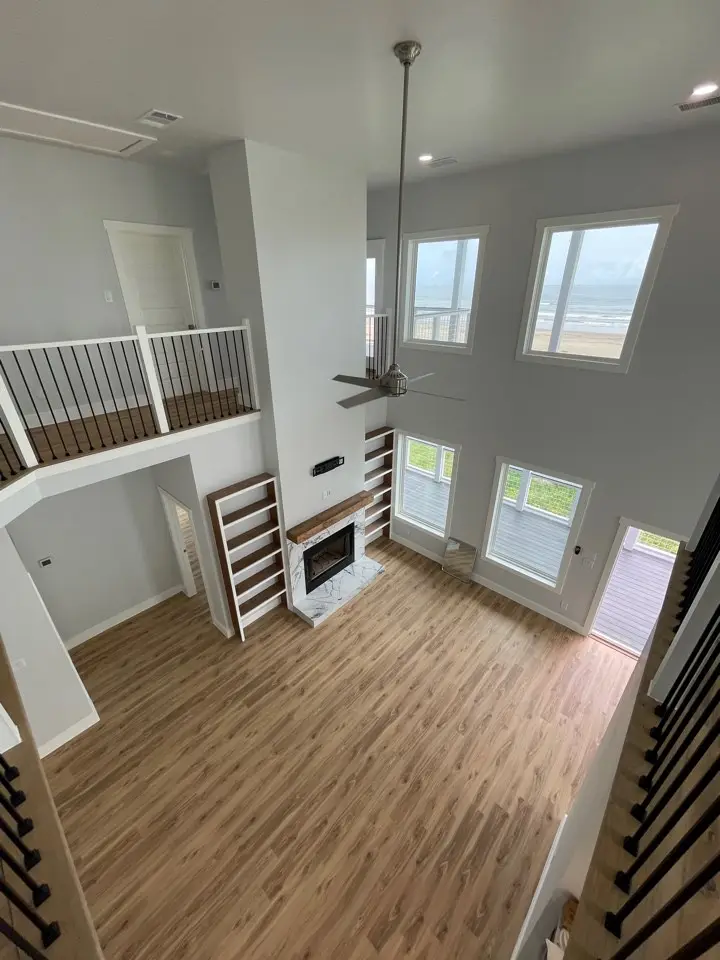 Upper loft area configured as a reading nook and flex space with panoramic views through tall windows on the third story