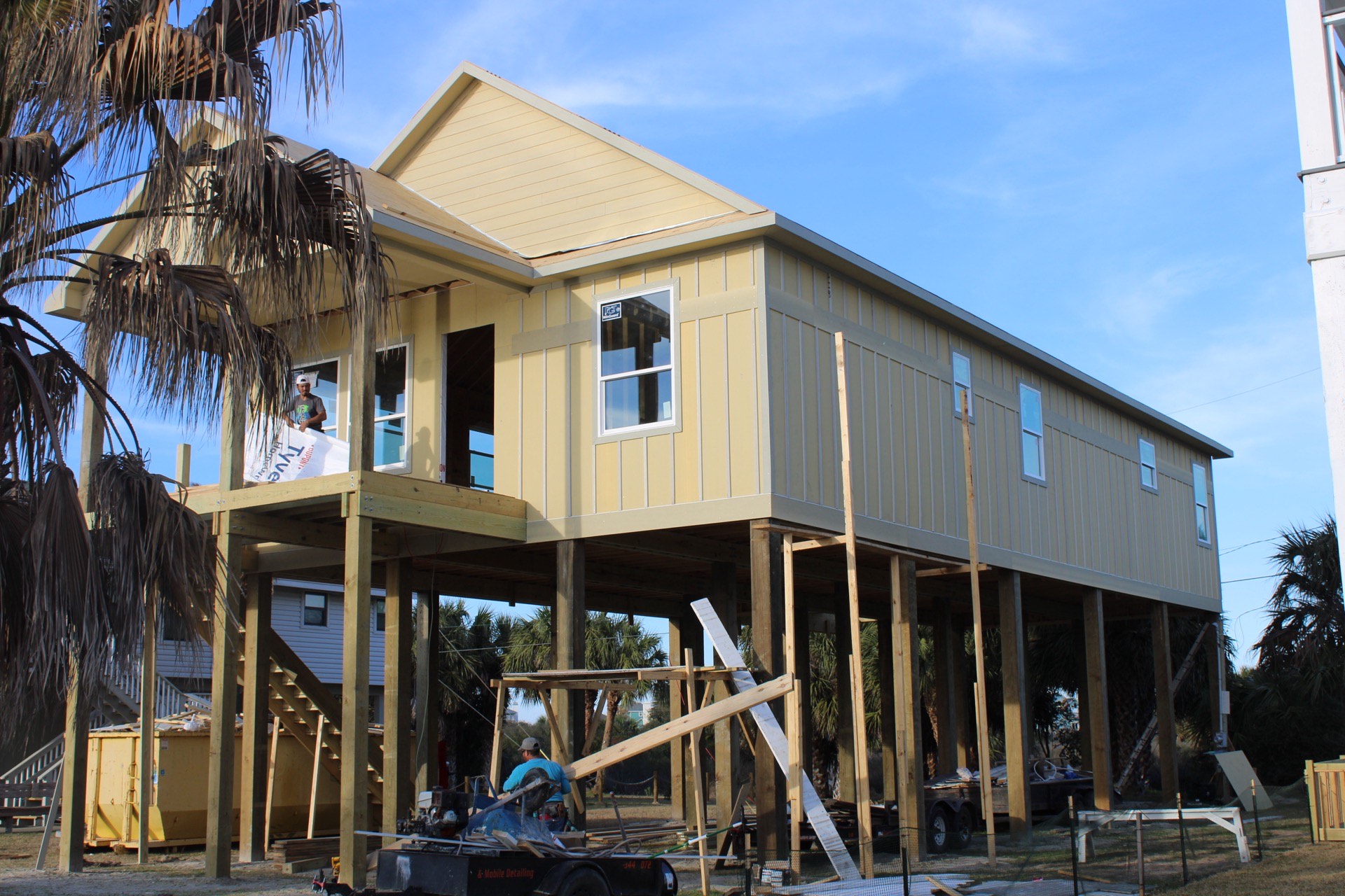 Master bedroom view toward the private covered deck through glass French doors with natural light flooding the room