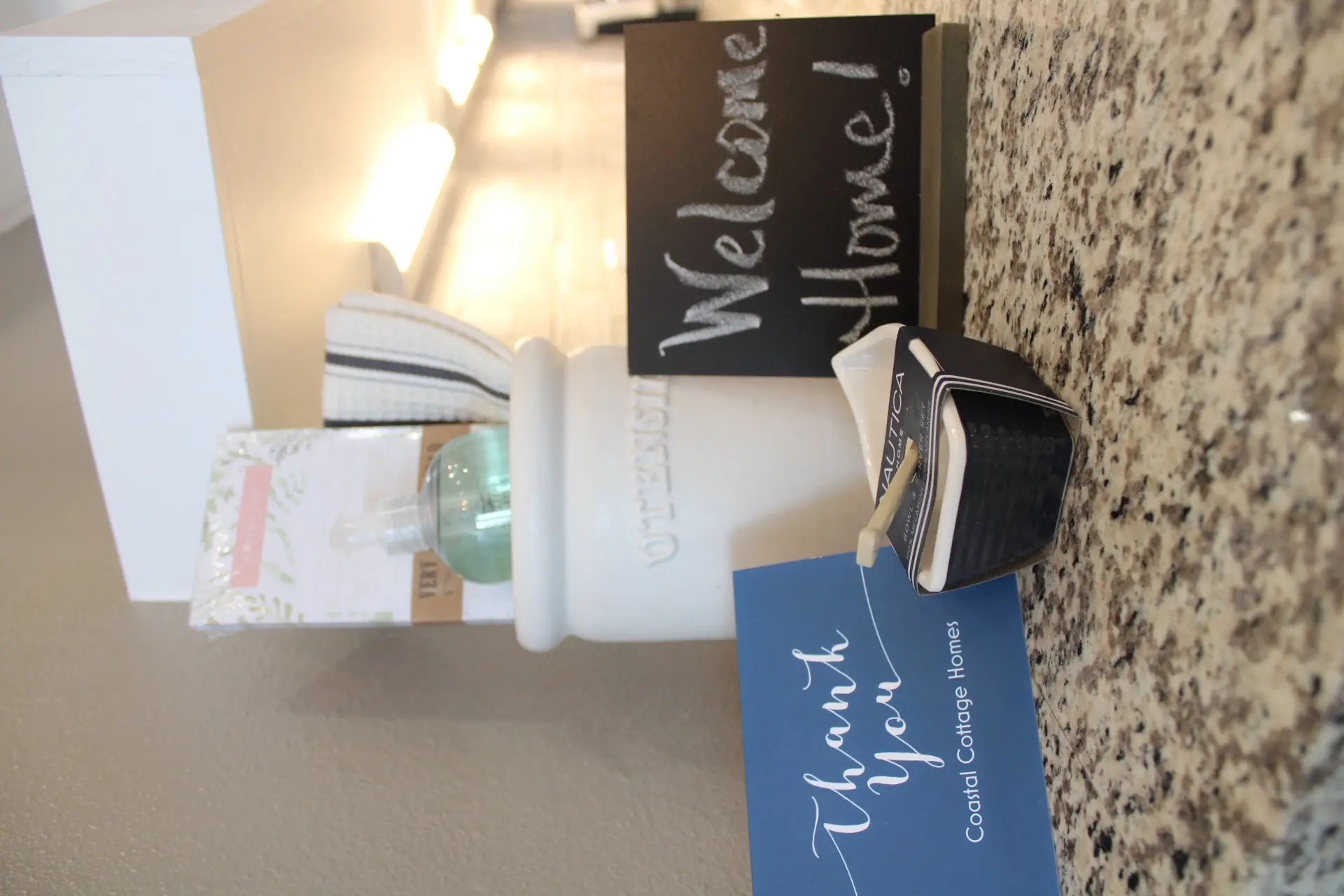 Bathroom vanity with granite countertop, black matte faucet and fixtures, and framed mirror in the 27 Laguna coastal cottage