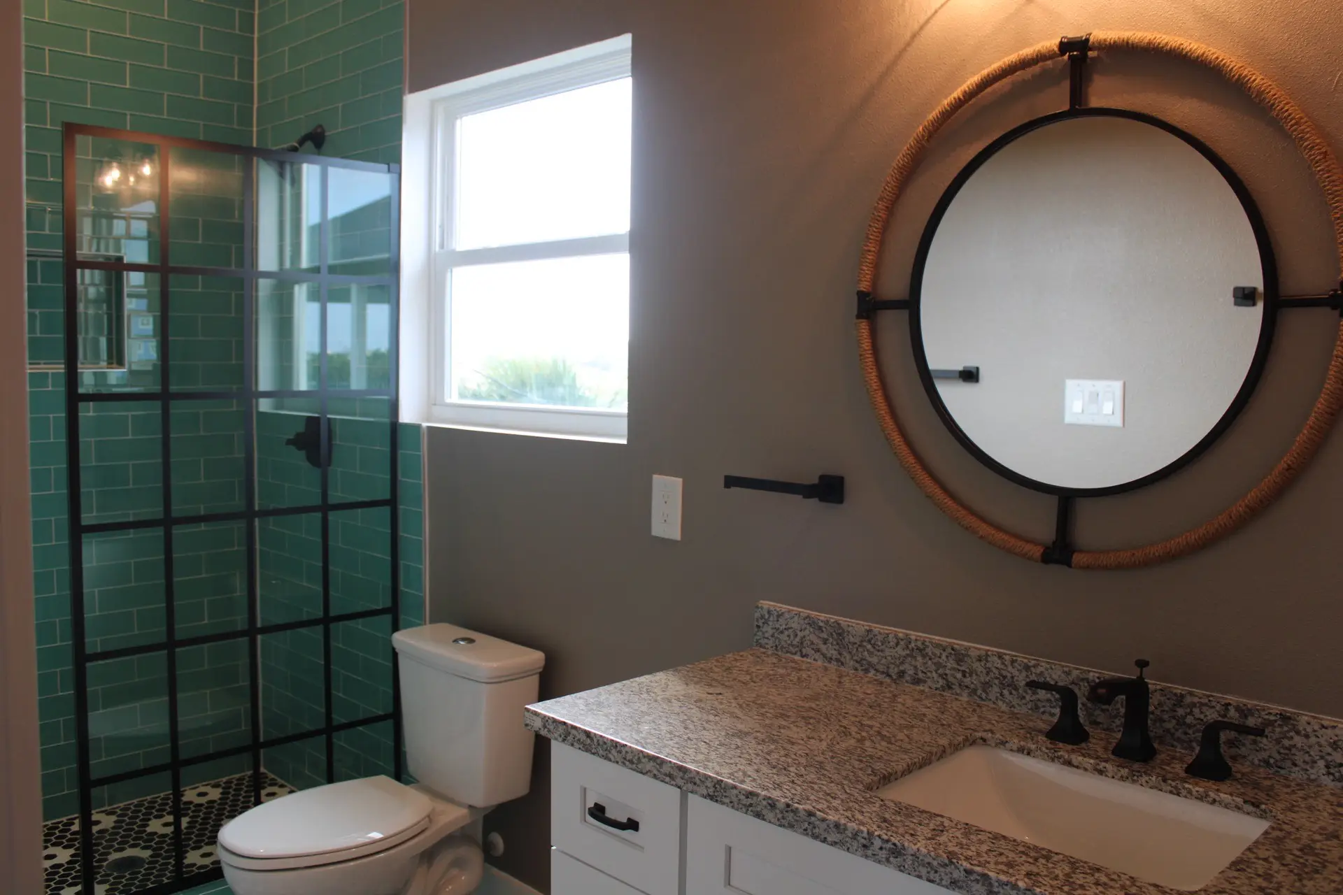 Laundry area and hallway detail showing LVP wood-look flooring, clean white trim, and black matte door hardware throughout the home