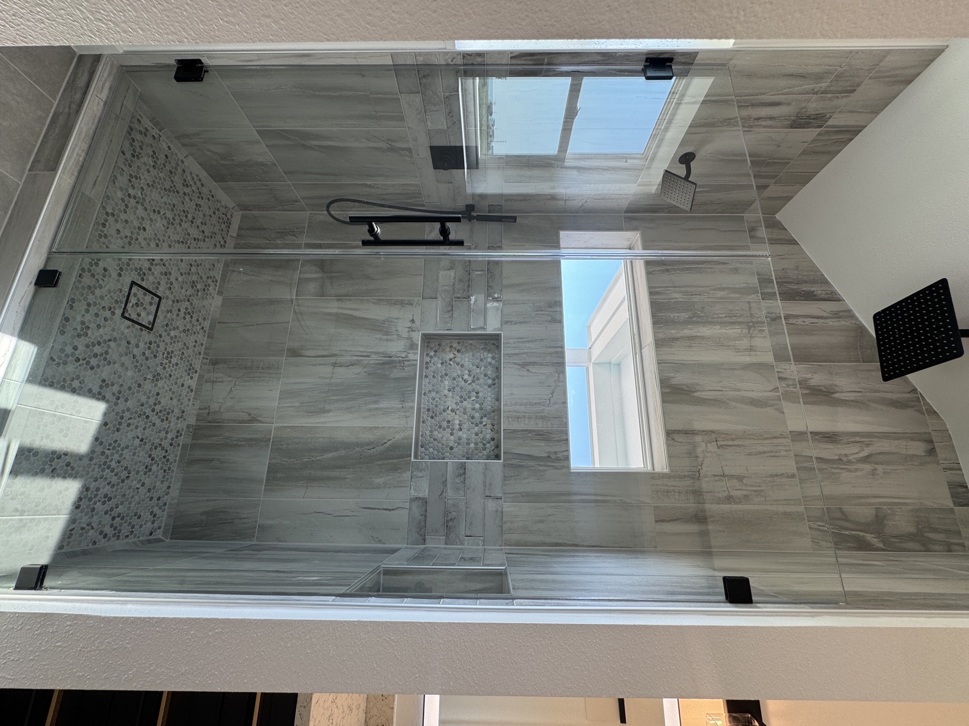 Rear exterior view of the 2nd Street property showing the bold teal and white color scheme, covered upper and lower porches, and proximity to the Galveston beach