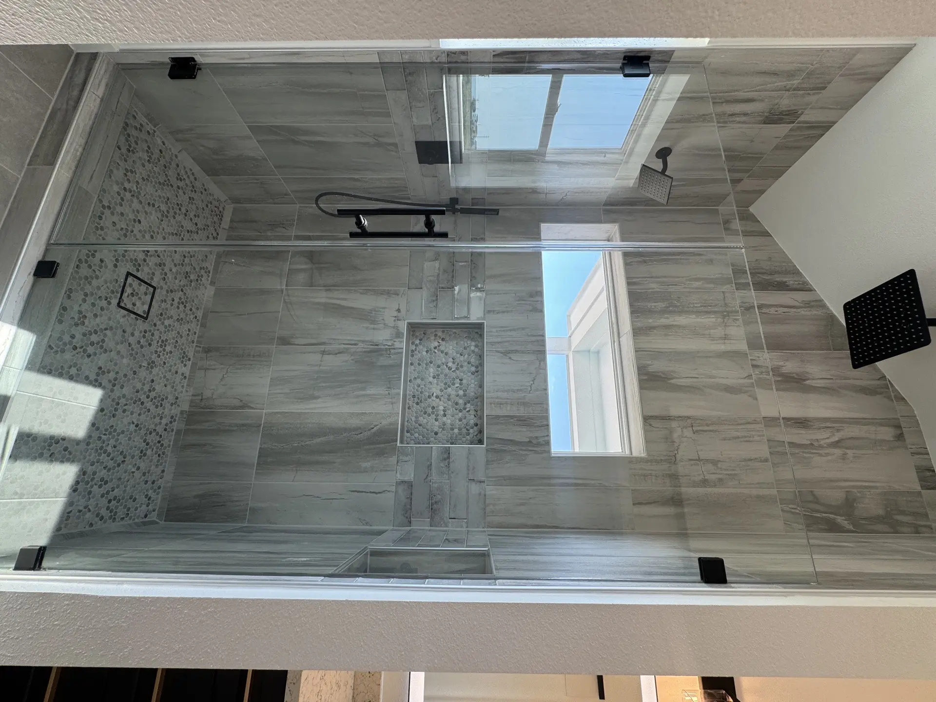 Rear exterior view of the 2nd Street property showing the bold teal and white color scheme, covered upper and lower porches, and proximity to the Galveston beach