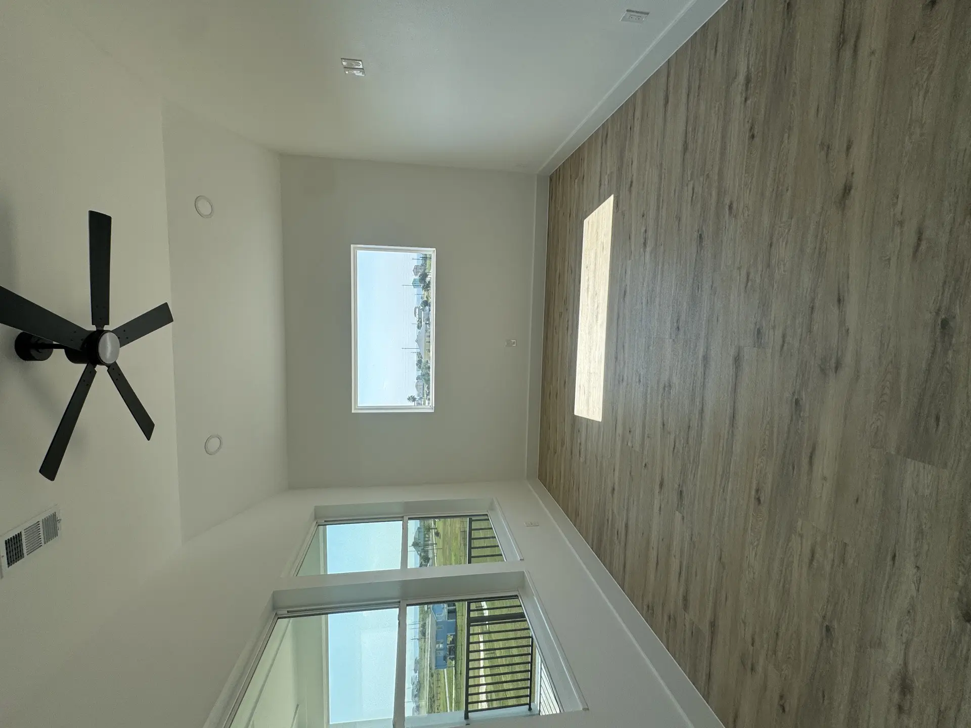 Large glass walk-in shower with gray marble-look tile walls and mosaic accent niche providing a spa-like experience in the master bathroom