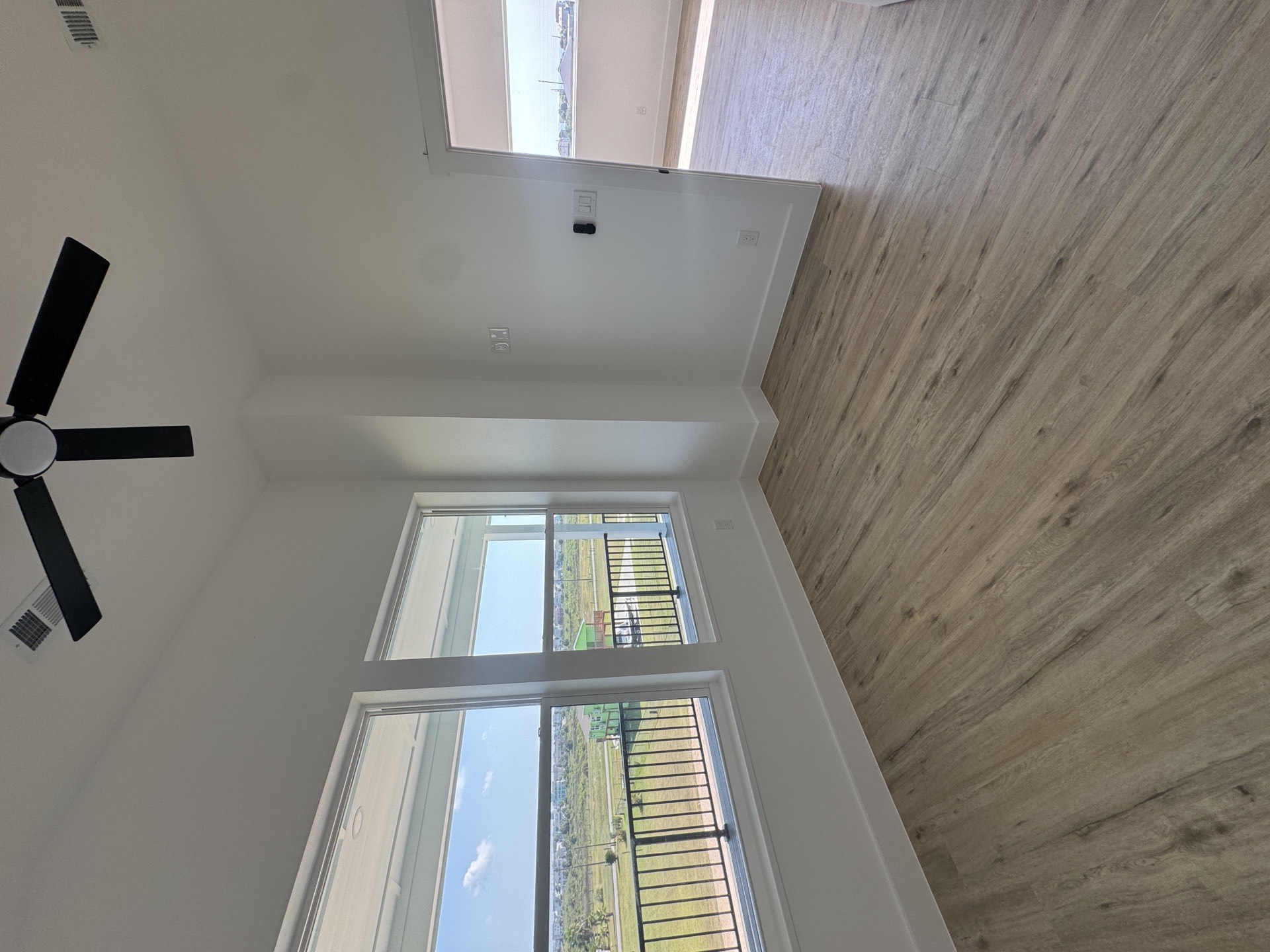 Freestanding soaking tub set on a patterned mosaic tile floor with modern fixtures and clean white walls in the master bath of the 2nd Street home
