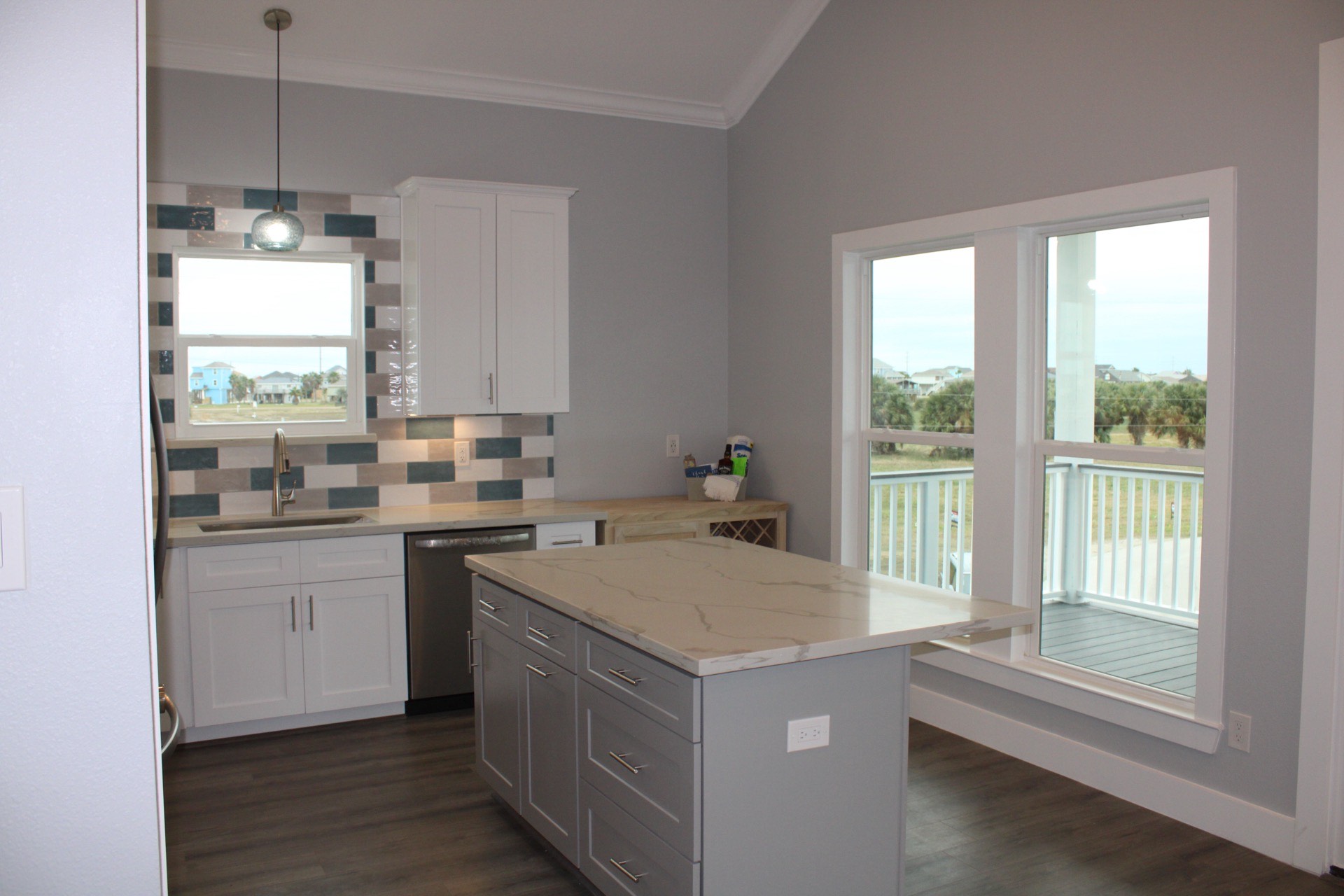 Bathroom with clean white tile, modern fixtures, and the gray and soft blue color palette that carries throughout 31 Laguna