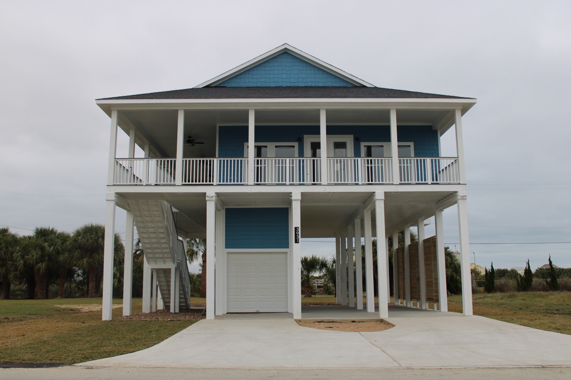 Kitchen island close-up showing marble and quartz countertop surface, pendant light fixtures above, and white cabinetry below