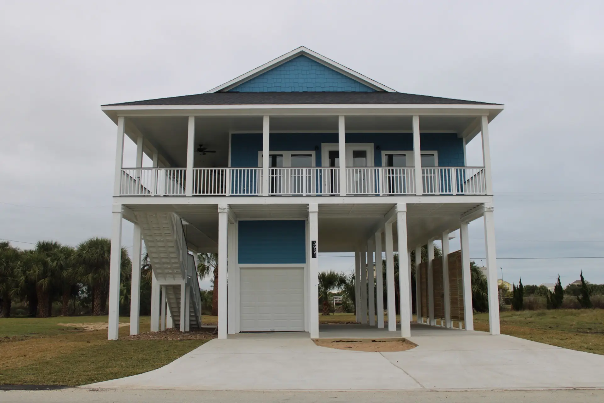Kitchen island close-up showing marble and quartz countertop surface, pendant light fixtures above, and white cabinetry below