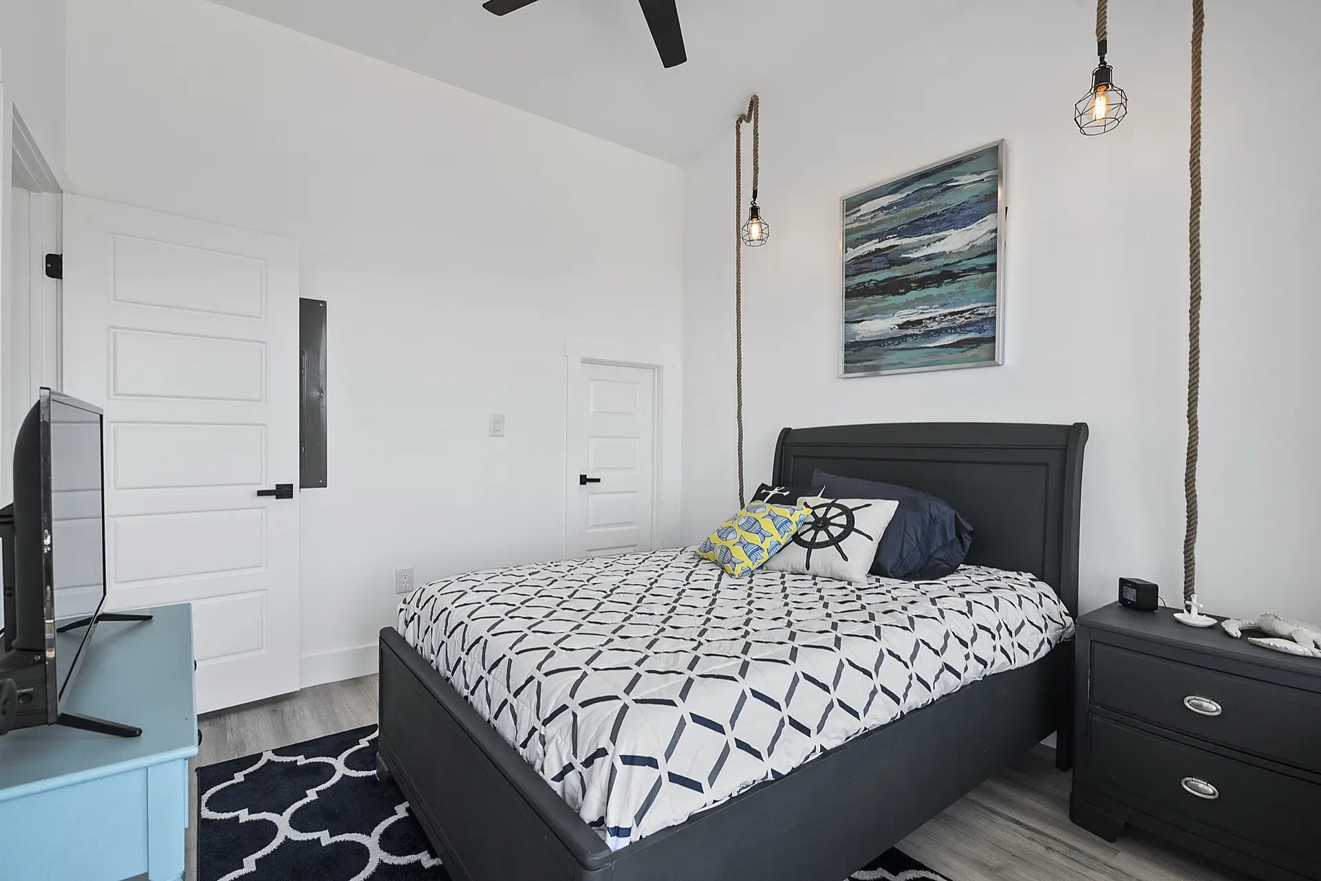 Wide view of the open-concept kitchen with white quartz surfaces, gold hardware throughout, and sightlines to the canal through large windows