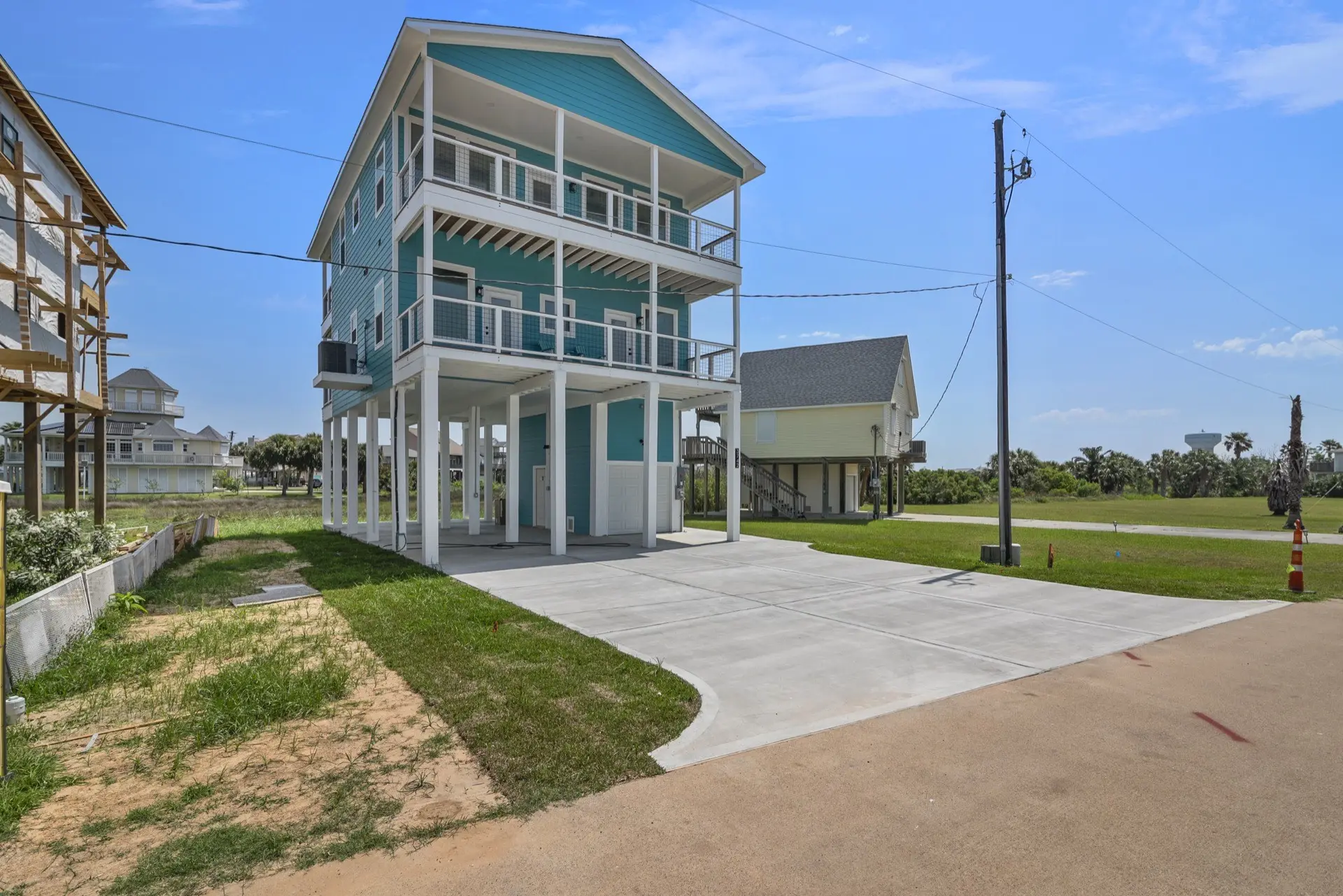 Kitchen dining counter with upholstered bar stools, pendant lights, and white quartz countertop extending from the main island