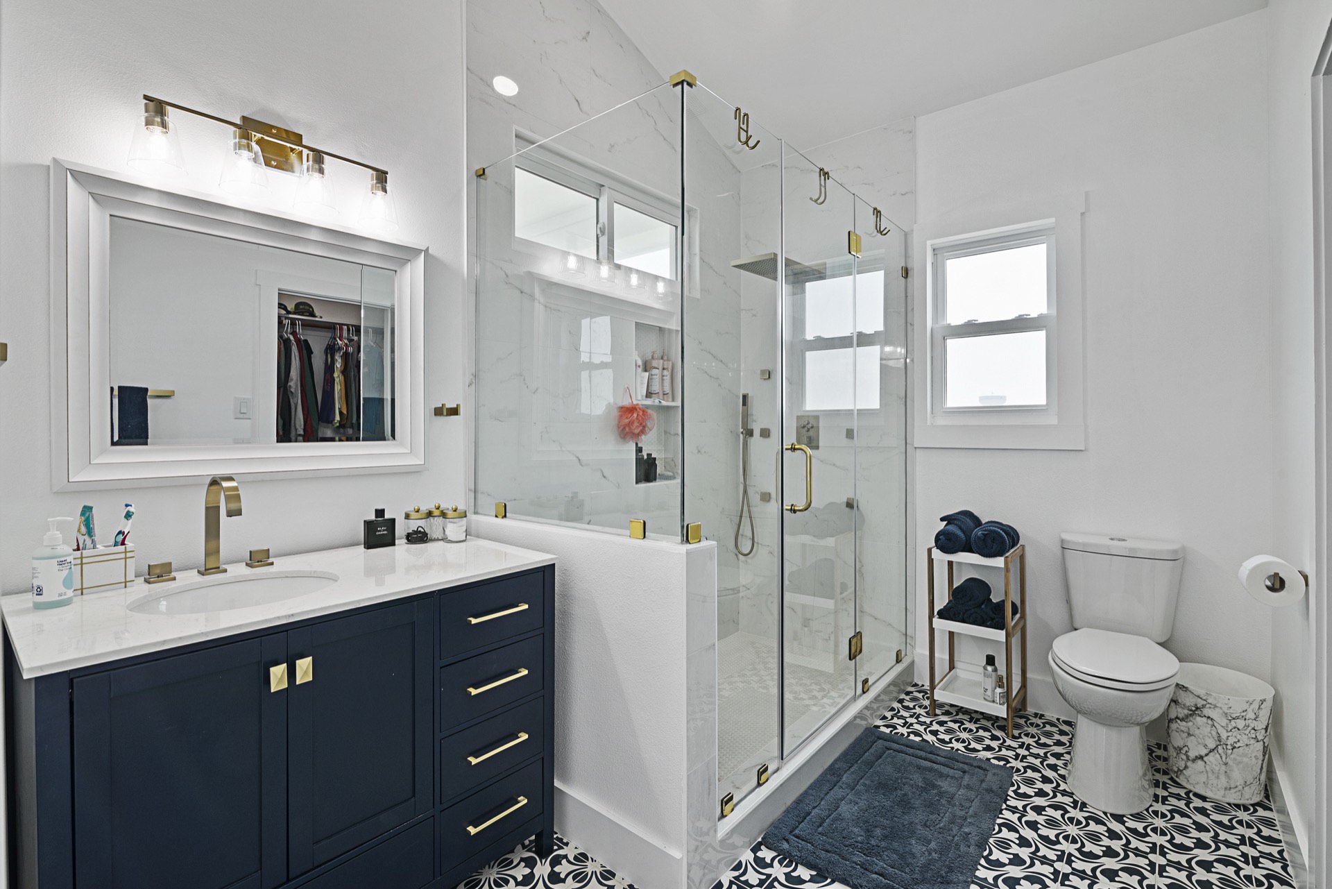 View from the living room toward the kitchen showing the seamless open floor plan, light flooring, and abundant natural light