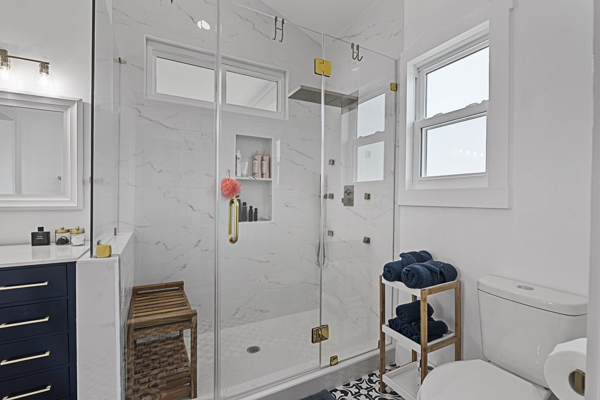 Built-in shelving detail flanking the shiplap fireplace wall with curated coastal decor and books in the 3742 Laguna great room