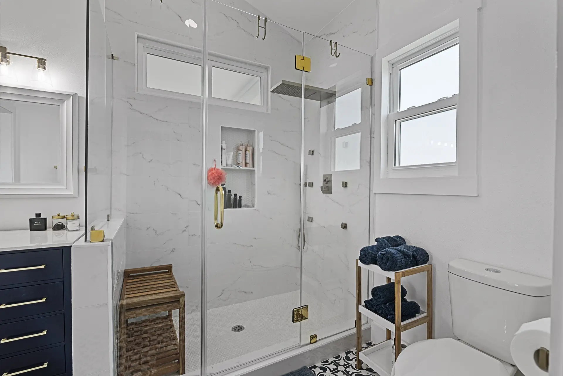 Built-in shelving detail flanking the shiplap fireplace wall with curated coastal decor and books in the 3742 Laguna great room