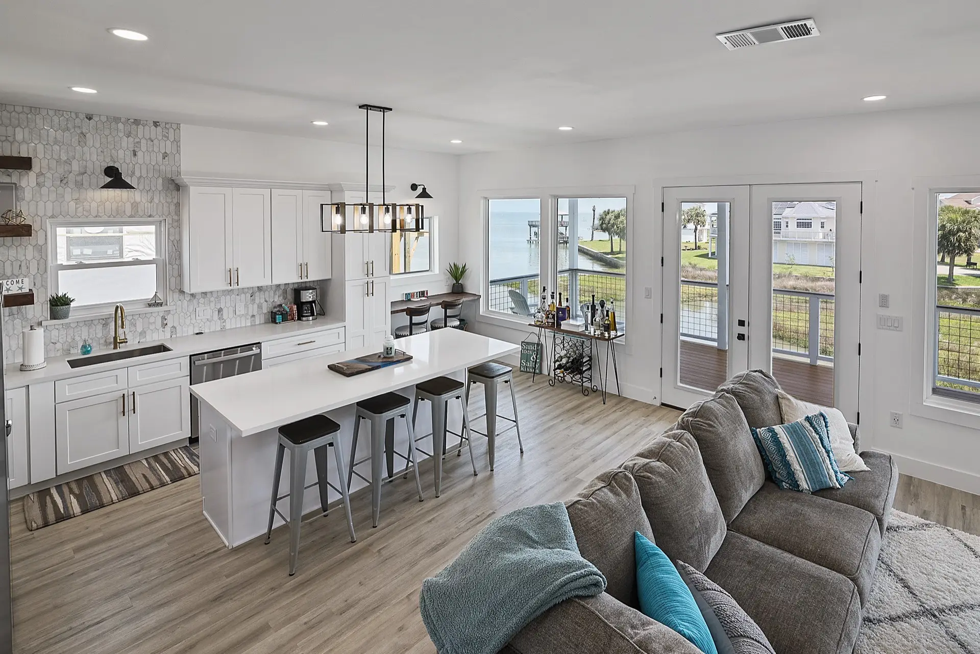 Master bathroom walk-in shower with large format tile, frameless glass door, and gold shower fixtures in the Tiki Island coastal home