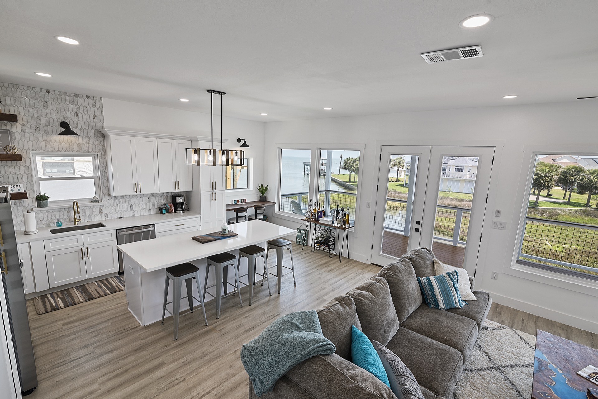 Black-and-white decorative floor tile closeup in the master bath with navy vanity and gold hardware visible in the background