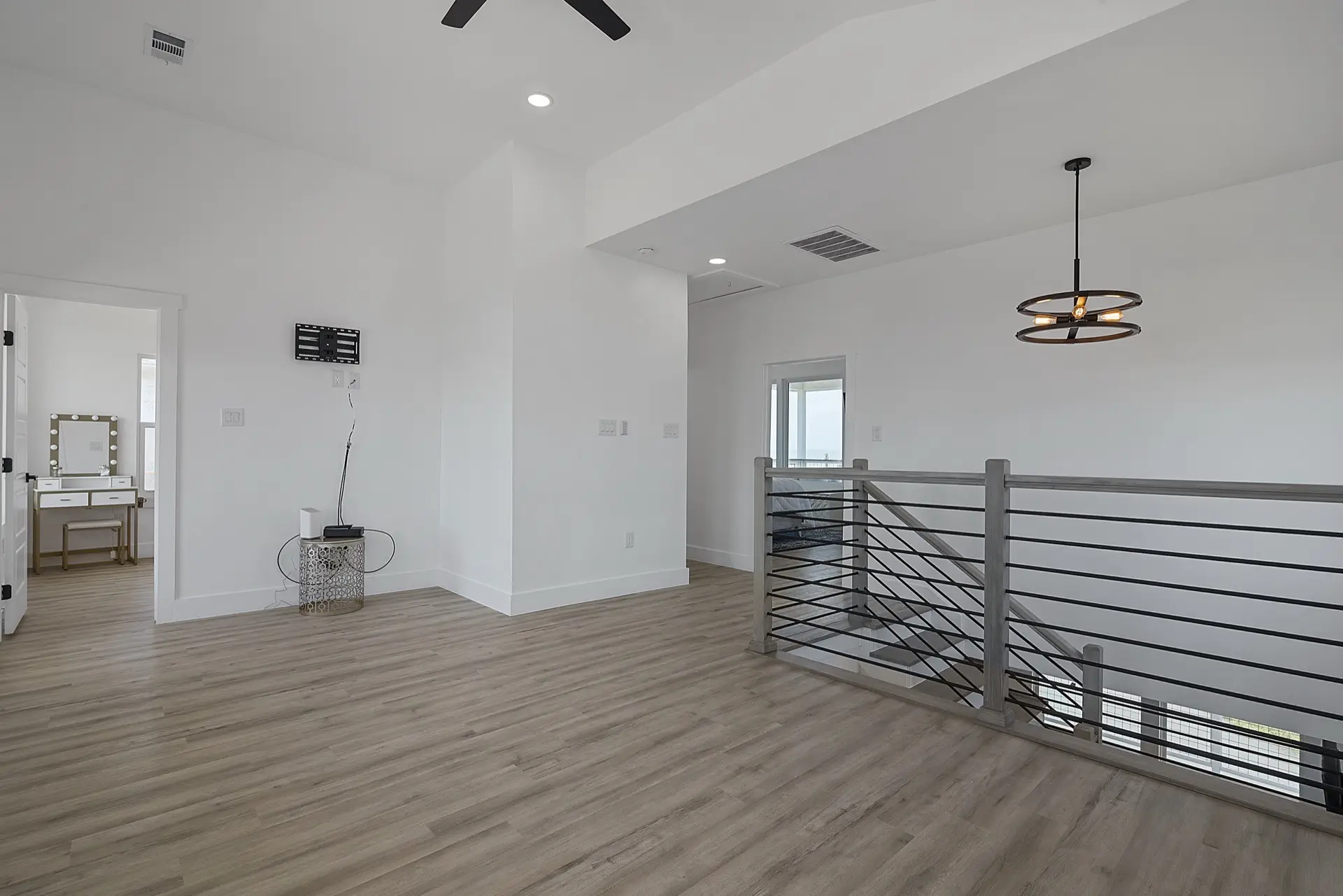 Second guest bedroom with ample natural light, modern ceiling fan, and tasteful coastal furnishings on Tiki Island