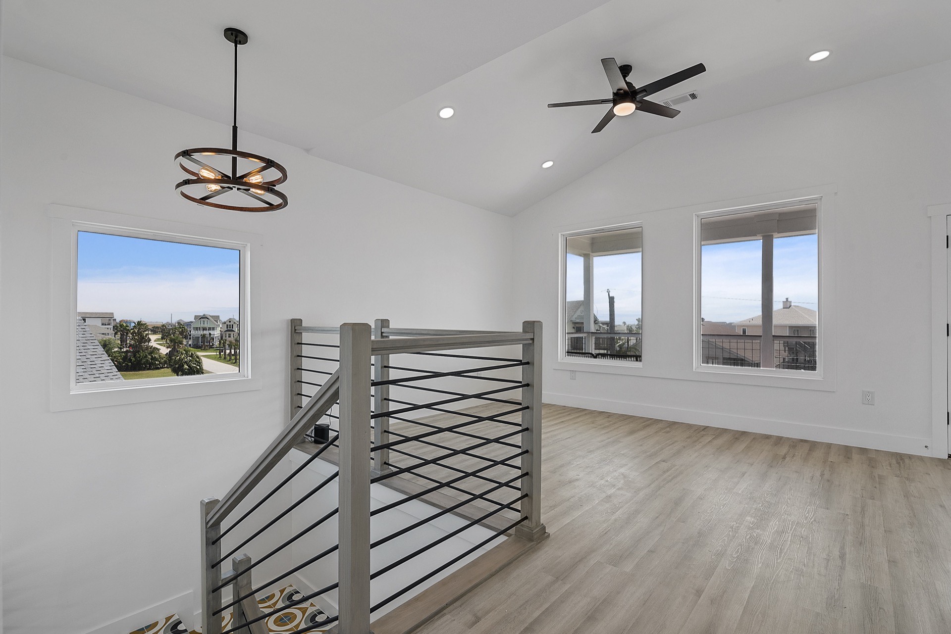 Third guest bedroom configured with twin beds, coastal artwork, and light-toned finishes in the upscale modern coastal home