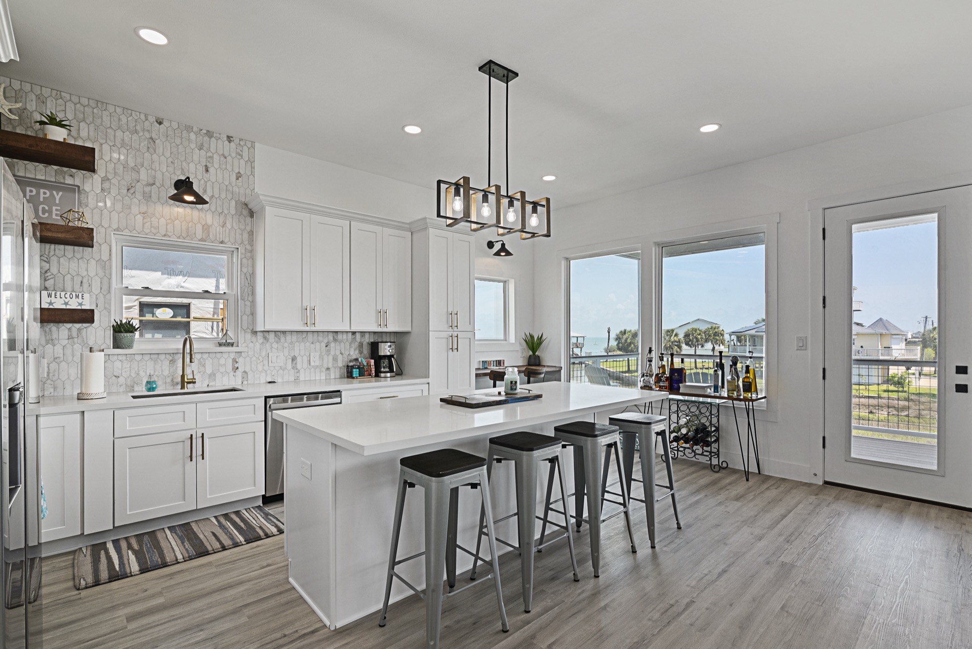 Cable railing detail along the deck perimeter providing unobstructed water views while maintaining a clean modern aesthetic