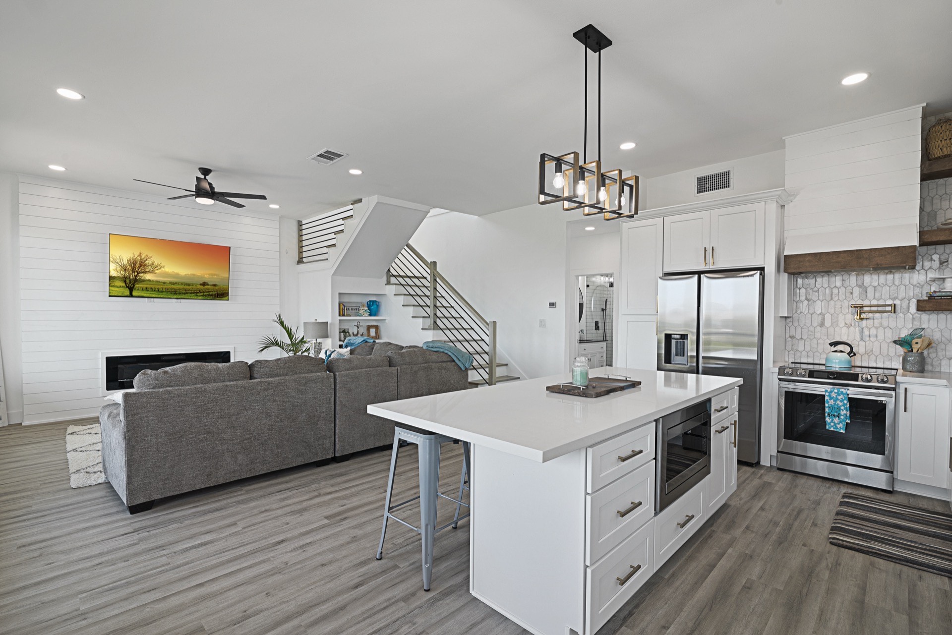 Panoramic waterfront view from the top deck showing the full canal, neighboring waterway, and Tiki Island coastal landscape