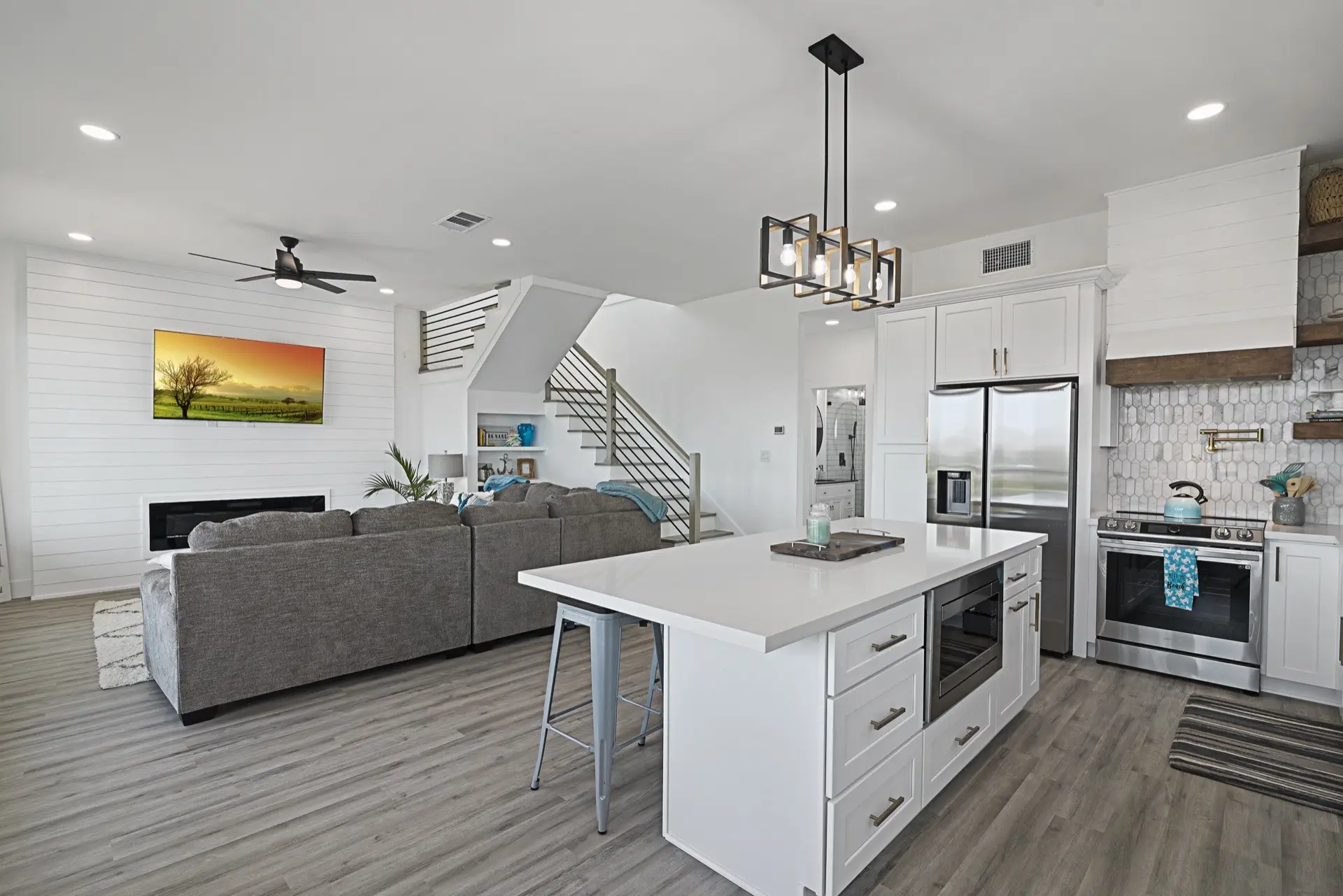 Panoramic waterfront view from the top deck showing the full canal, neighboring waterway, and Tiki Island coastal landscape