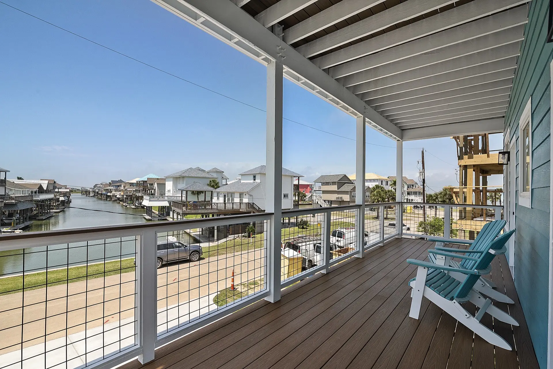Kitchen island detail showing white quartz countertop, navy blue base cabinetry, gold cabinet hardware, and waterfall edge profile