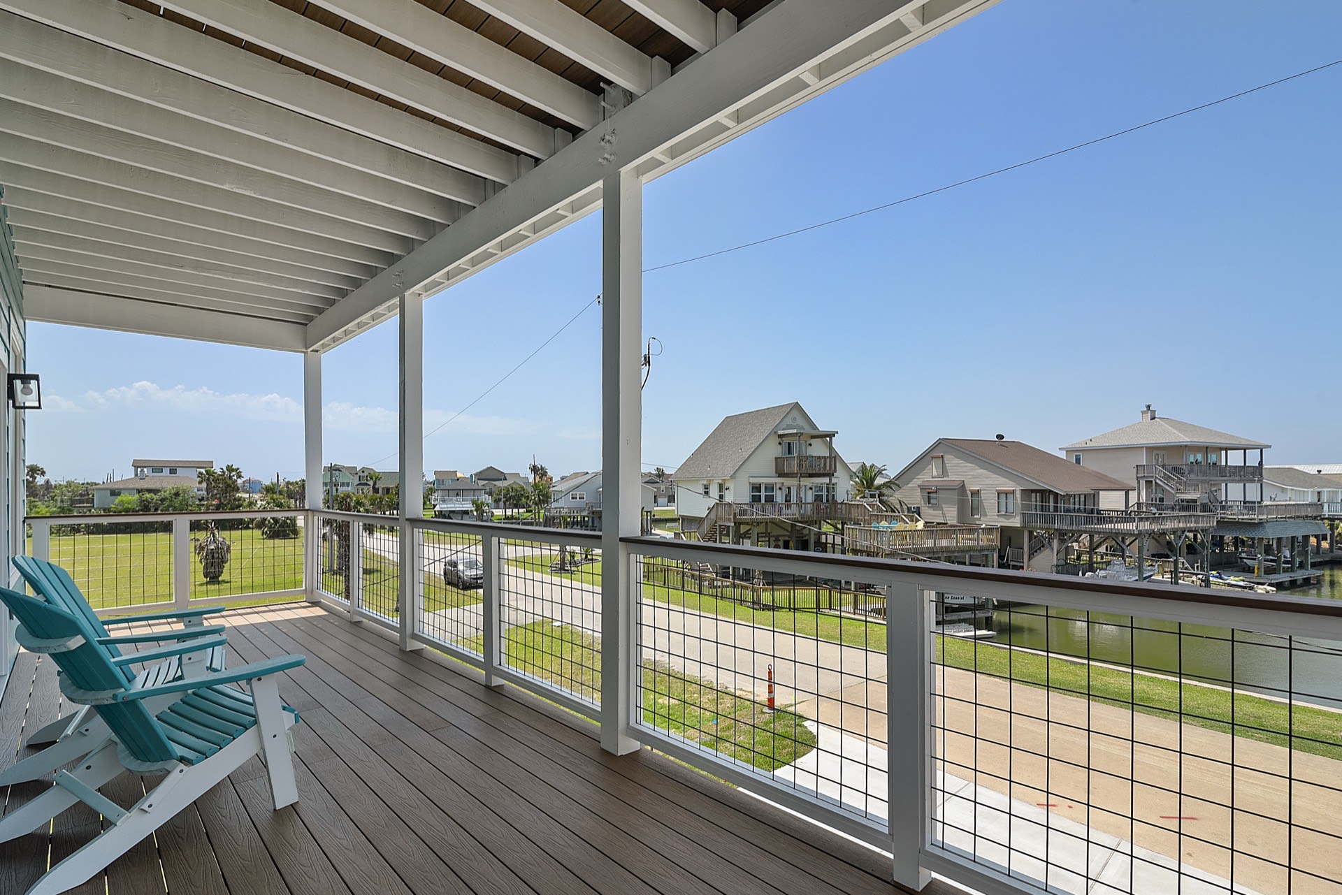 Built-in stainless steel wine cooler and beverage center integrated into the kitchen cabinetry with gold pulls at 3742 Laguna