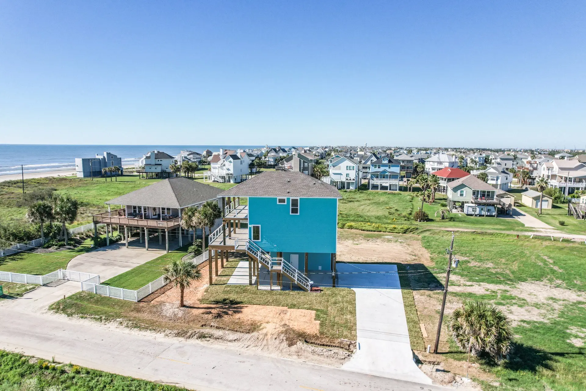 Aerial perspective of 4003 Pirates Beach custom home with elevated construction on pilings and ocean-facing decks