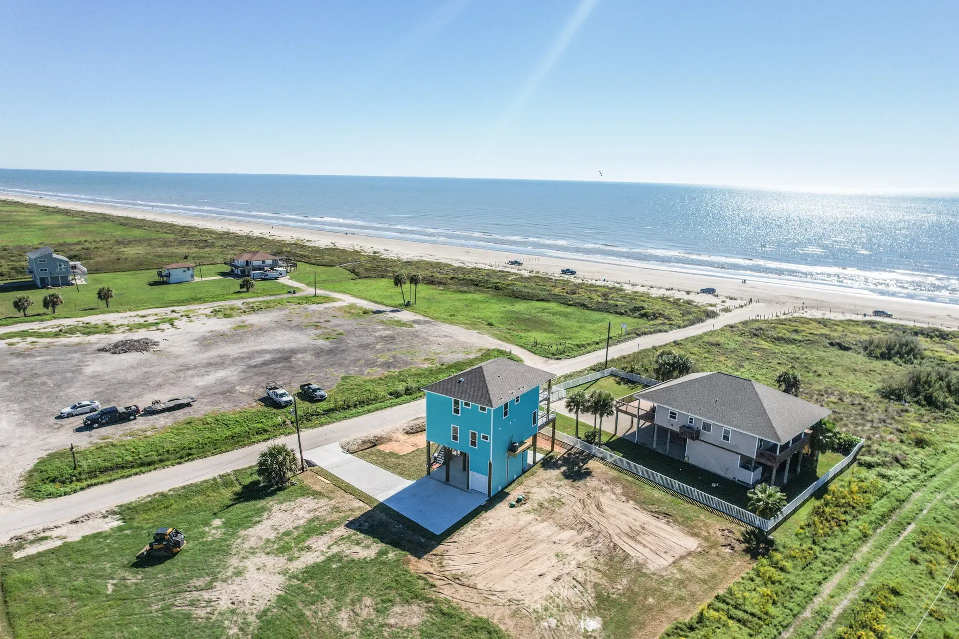 4003 Pirates Beach home aerial showing neighboring beachfront lots and Gulf Coast shoreline