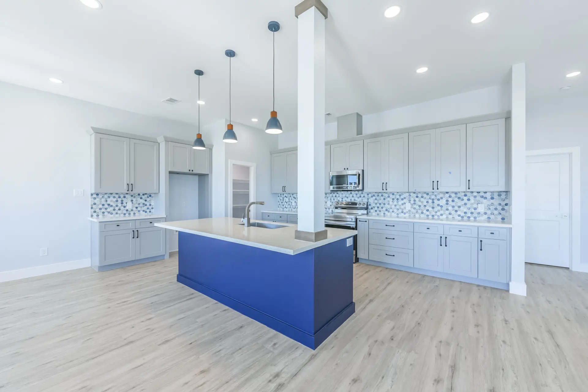 Kitchen and dining area open floor plan view at 4003 Pirates Beach custom coastal home