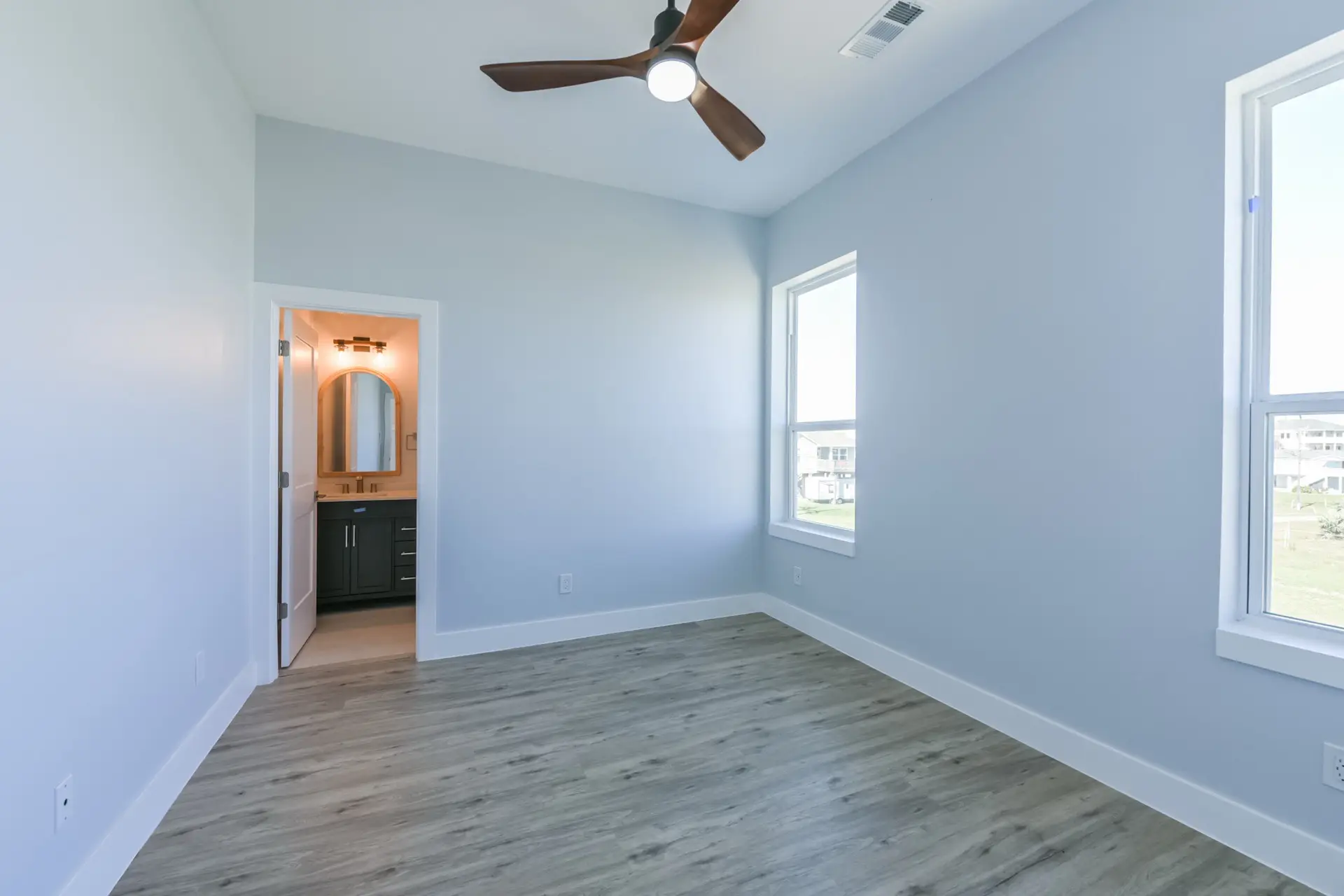 Primary bathroom with dual vanity, designer tile, and frameless glass shower at 4003 Pirates Beach
