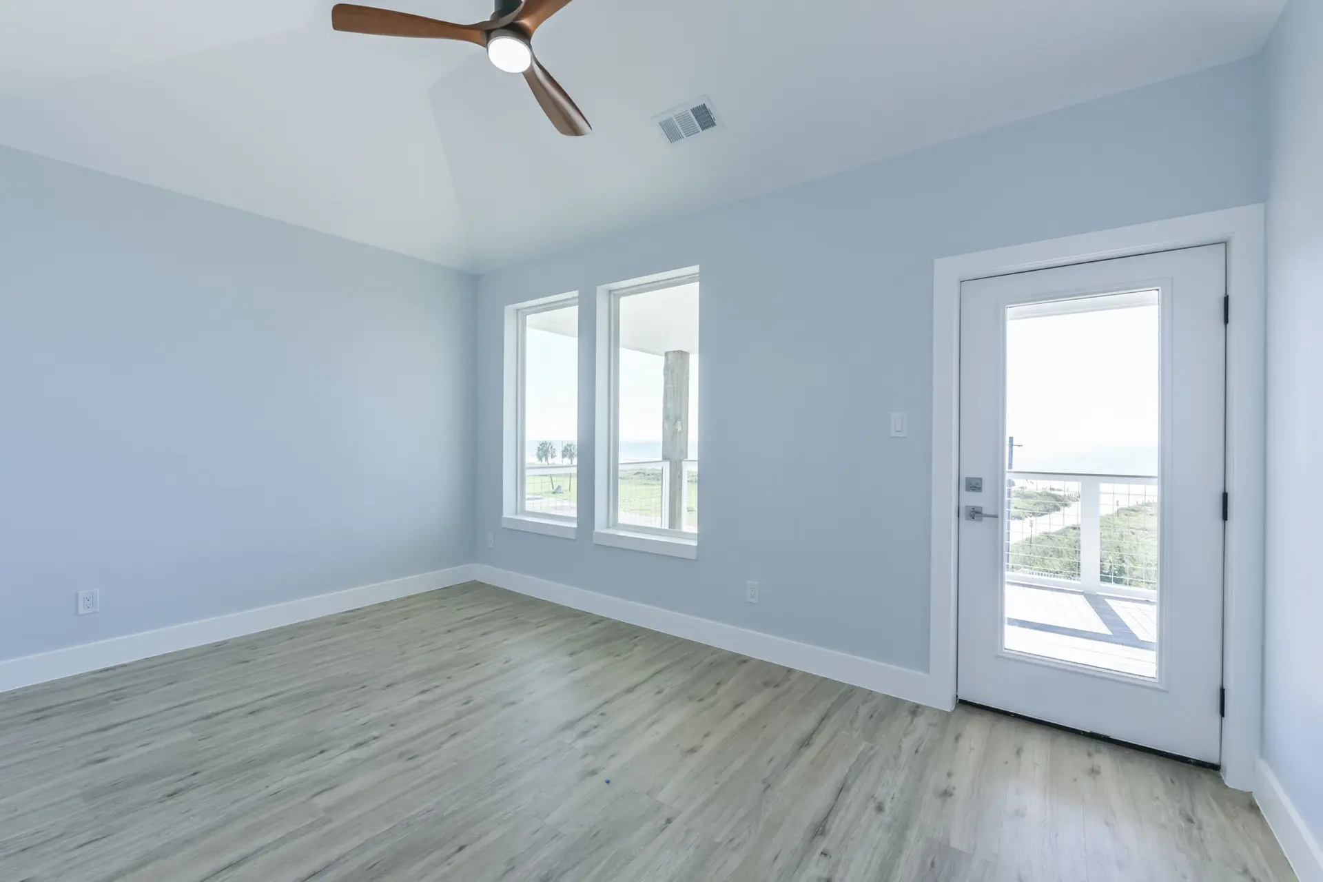 Bedroom with vaulted ceiling and architectural detail at 4003 Pirates Beach elevated home