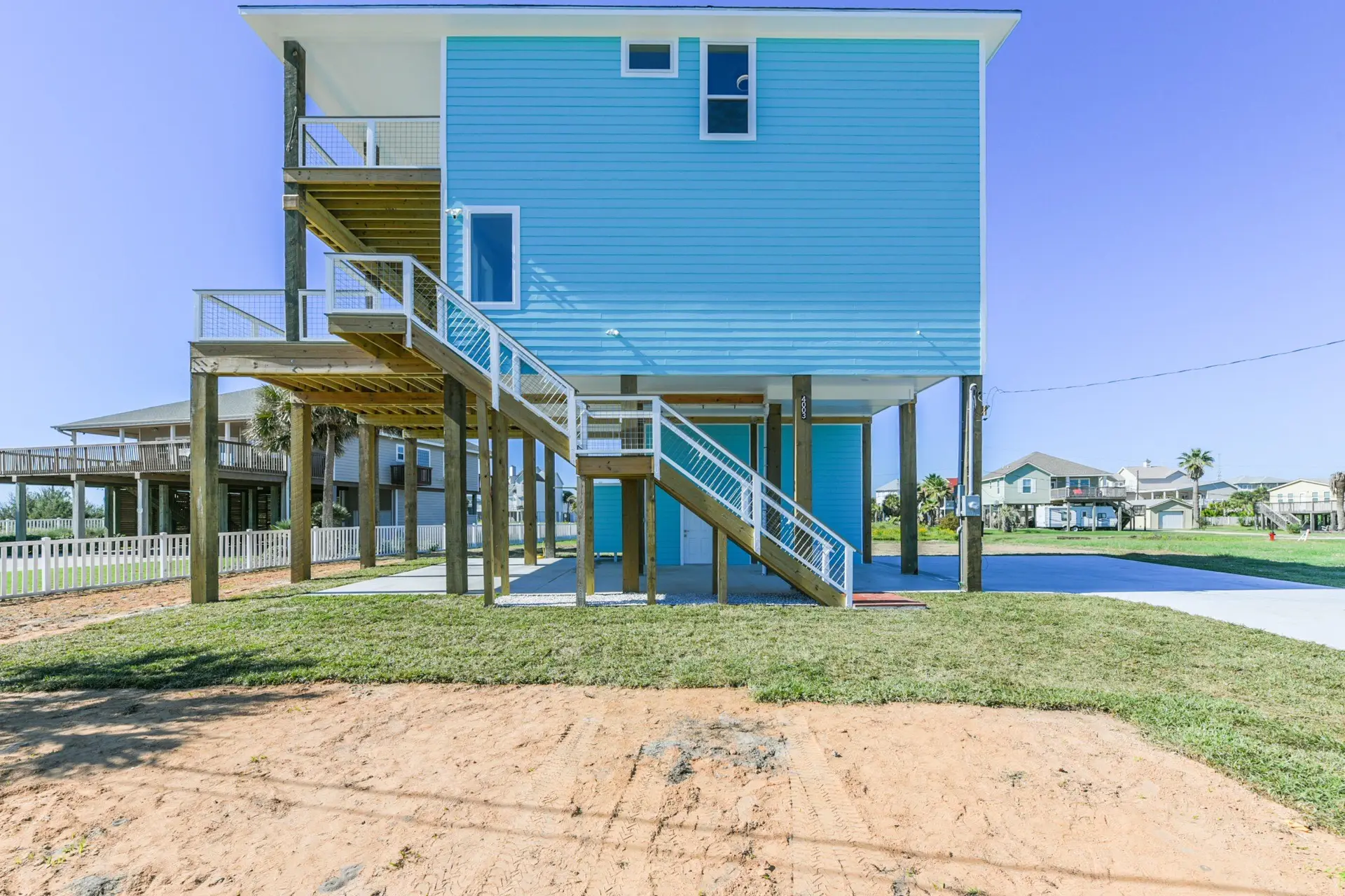 4003 Pirates Beach exterior showing sturdy piling construction and covered ground-level parking
