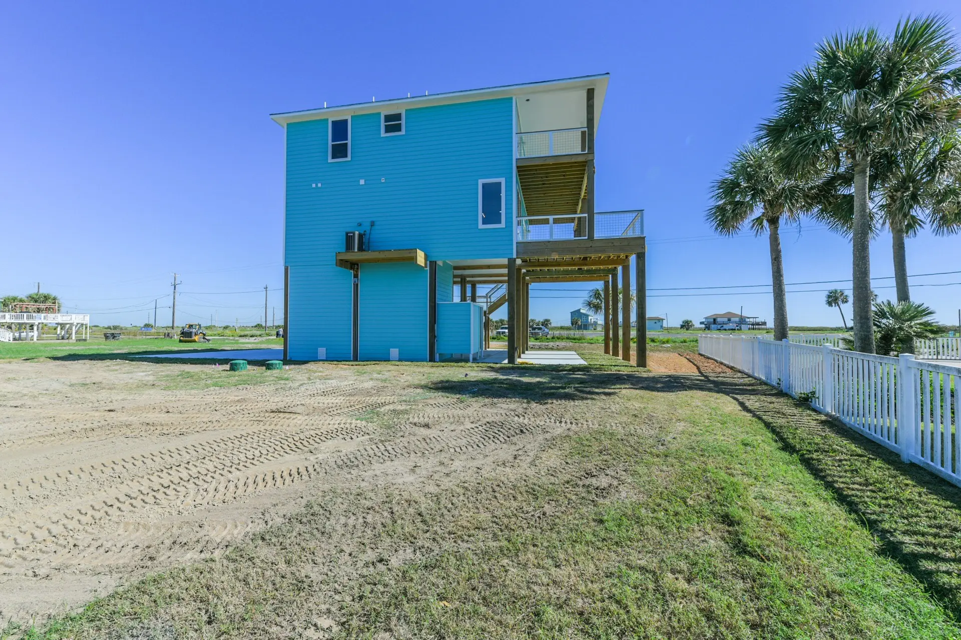 Rear exterior of 4003 Pirates Beach home with multiple Gulf-facing decks and balconies